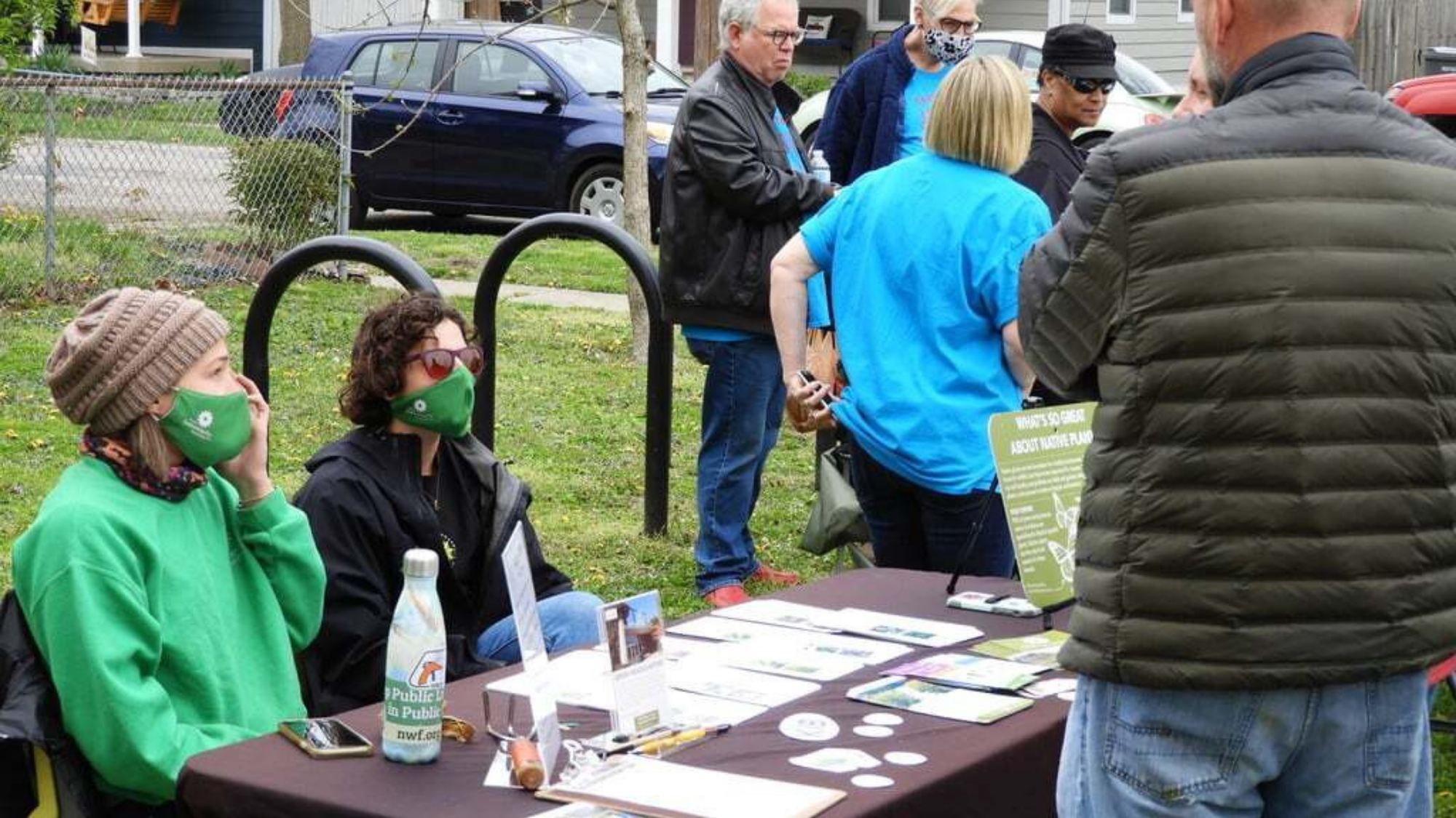 Community members sit at a table at a community event