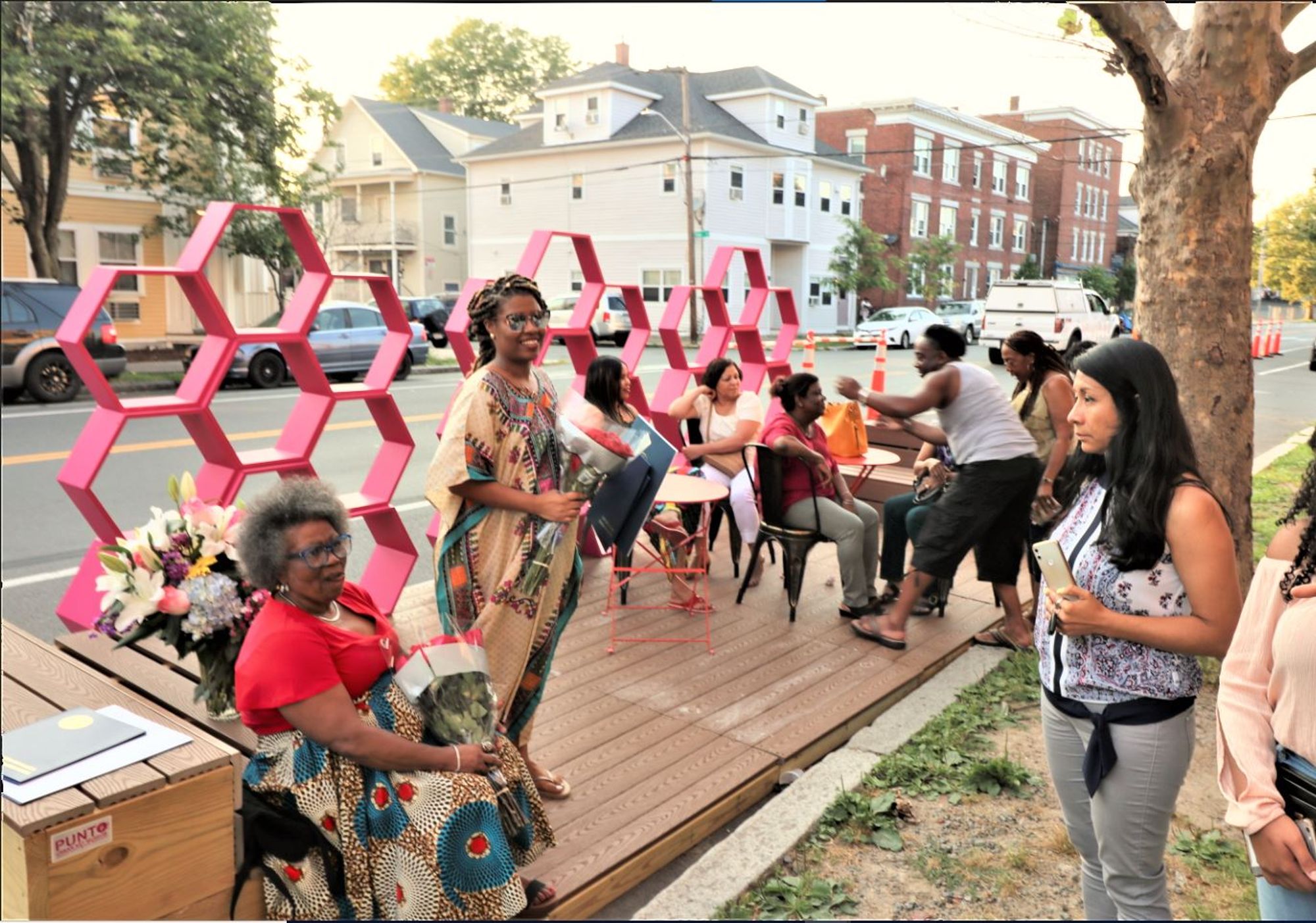 A parklet space installation on Congress Street with seating and shading from the street.