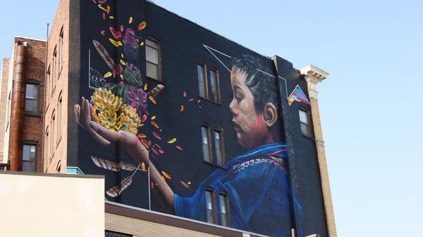Lynn Beyond Walls Mural of a boy holding a flower