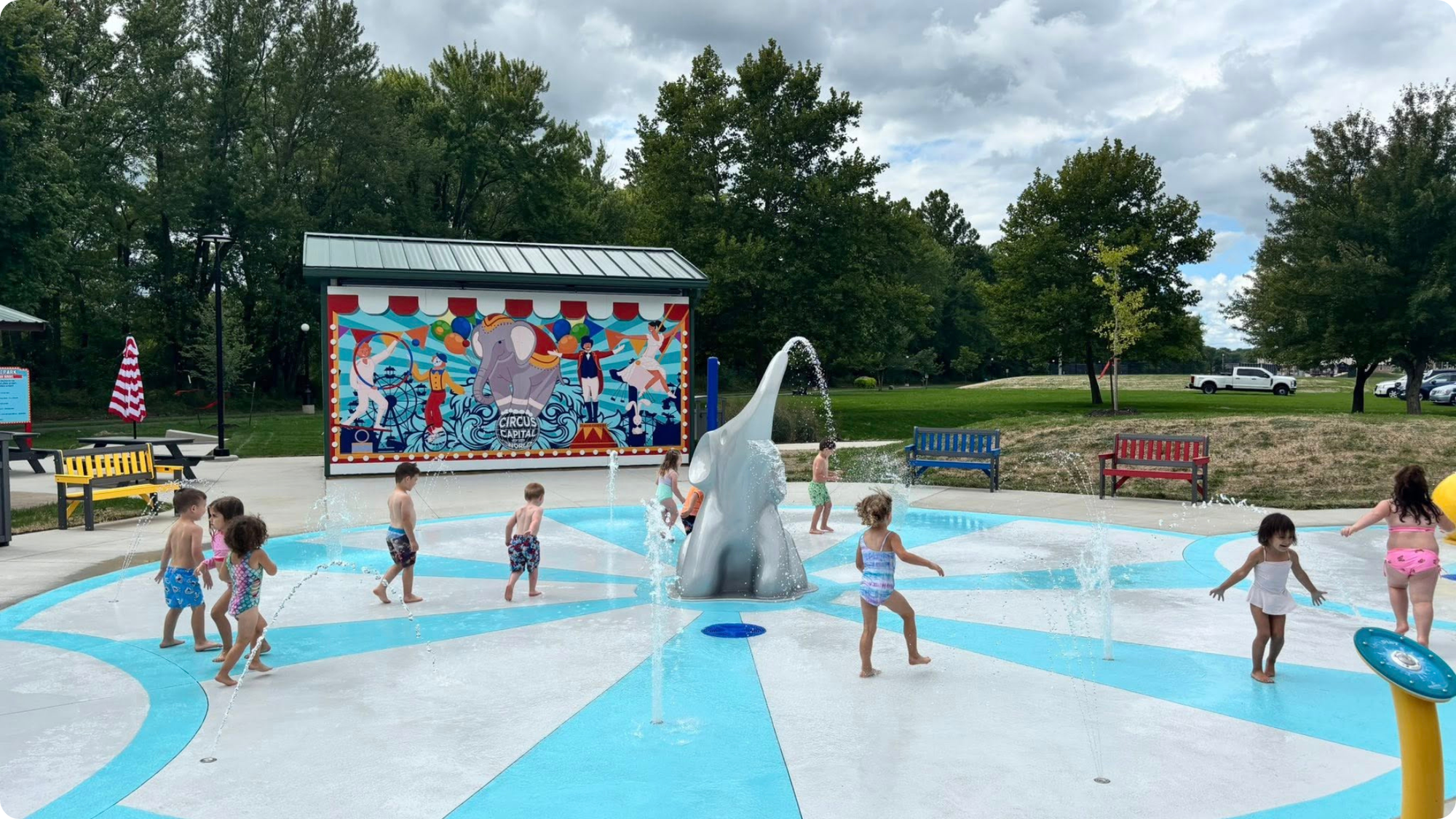 Children run through the circus-themed splash pad in Peru, Indiana.