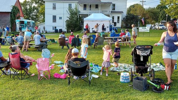 Community members enjoy an outdoor concert in Vermont. 