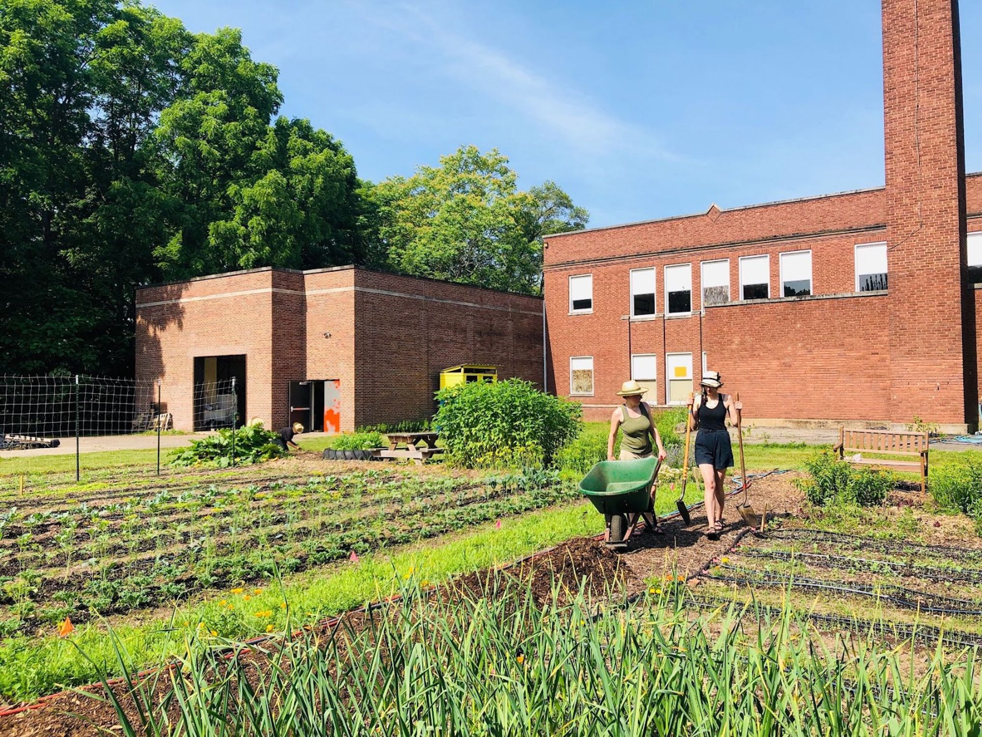 Community members gardening outside the former Huss School