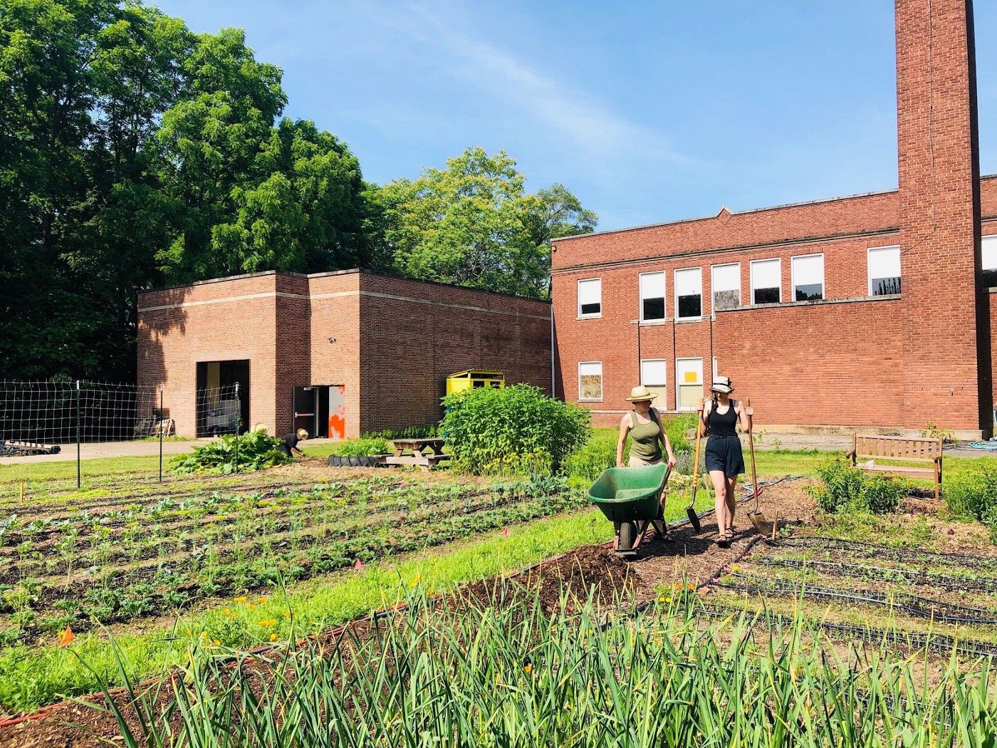 Community members gardening outside the former Huss School