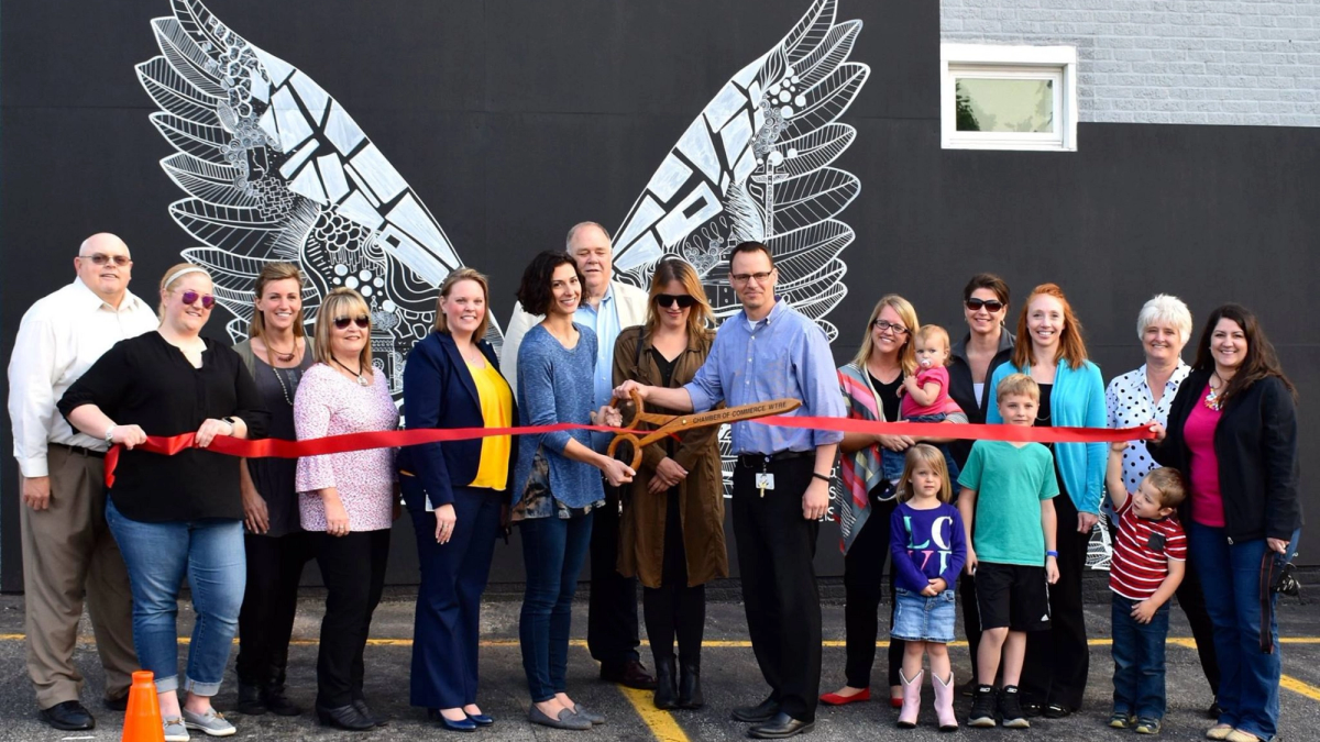 A ribbon cutting ceremony for a mural of wings in Greensburg, Indiana.