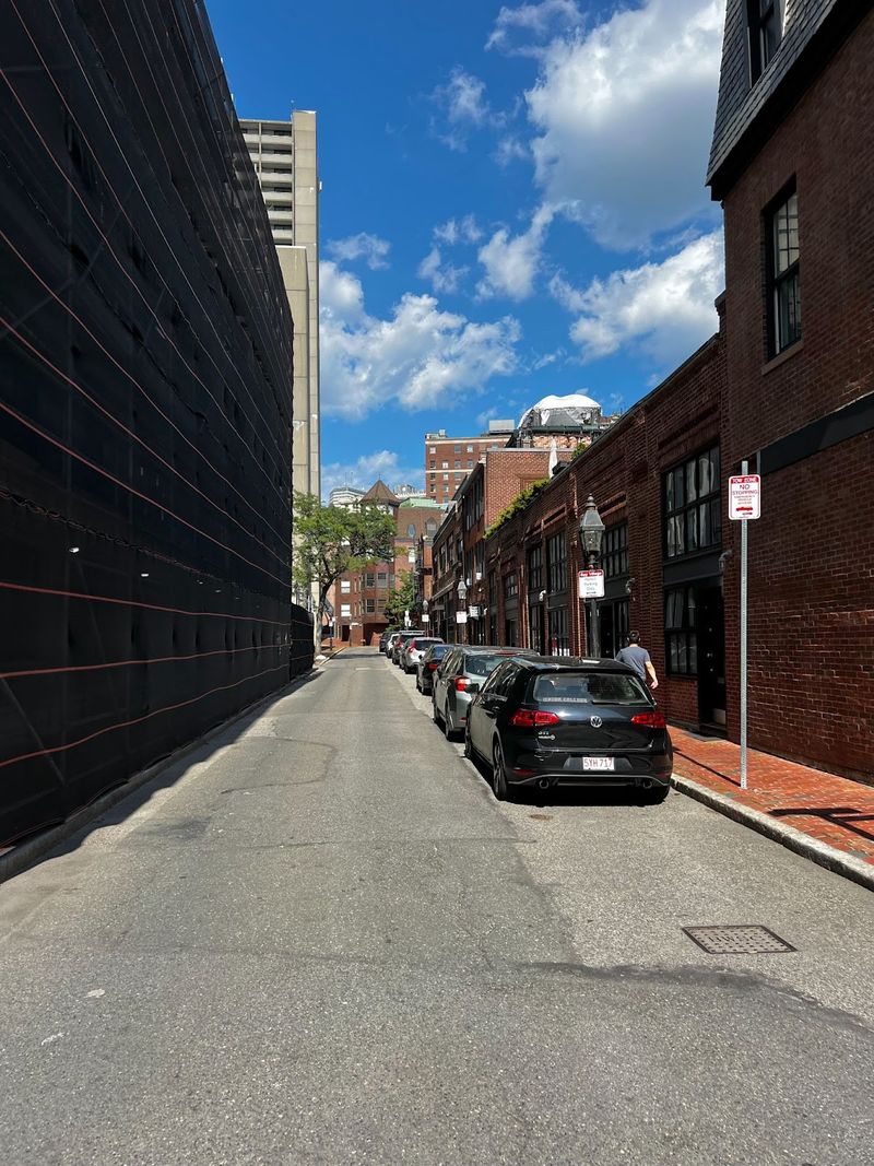 A Boston Street on a hot summer day without the benefit of street trees for shading.