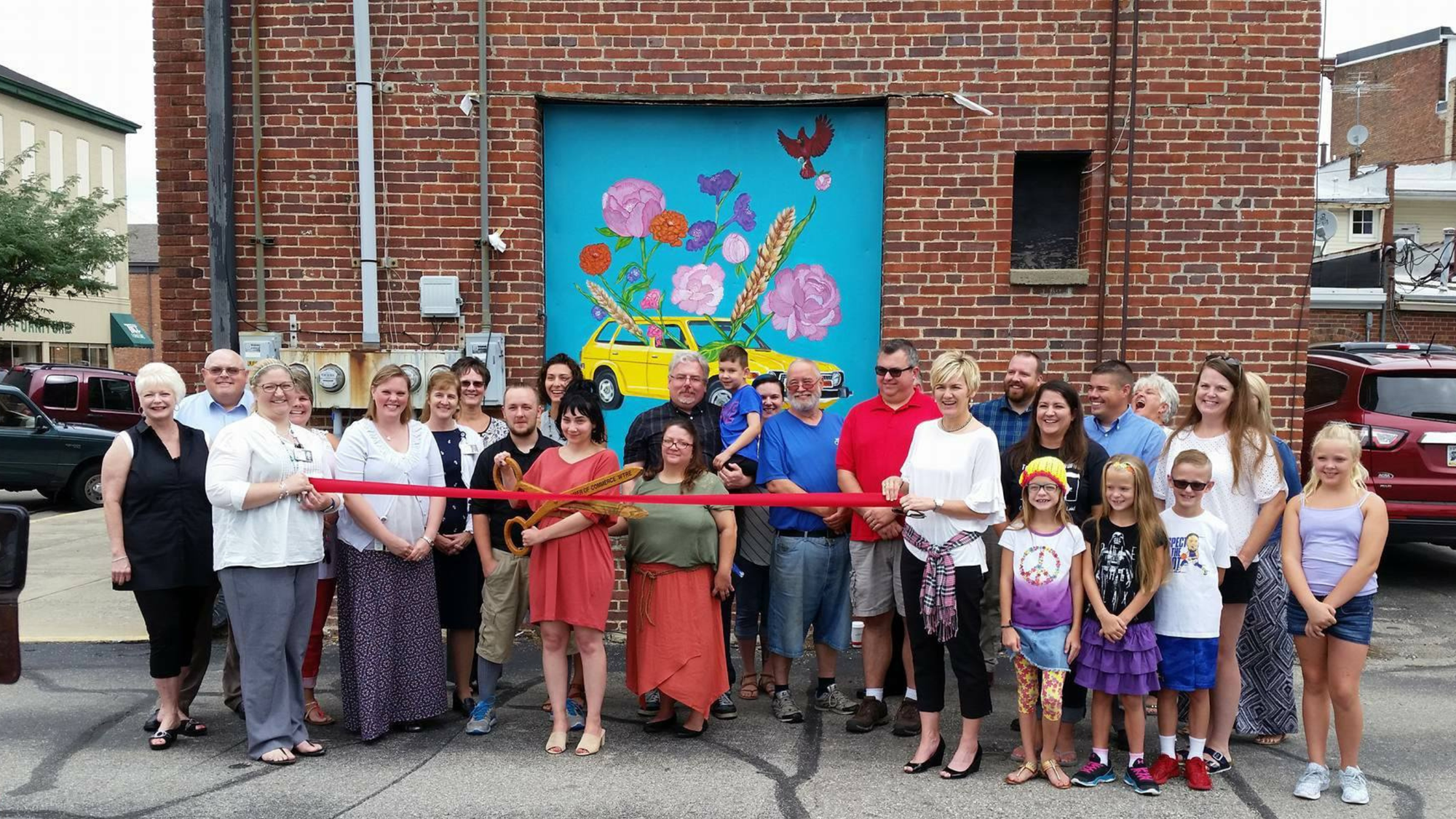 The ribbon cutting for one of the #DistinctivePlace murals in downtown Greensburg. 