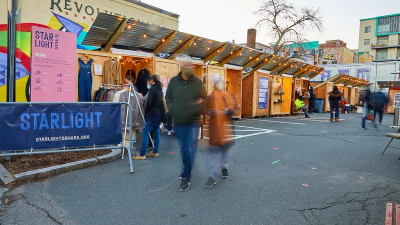 People walk through the outdoor Popportunity Winter Market.