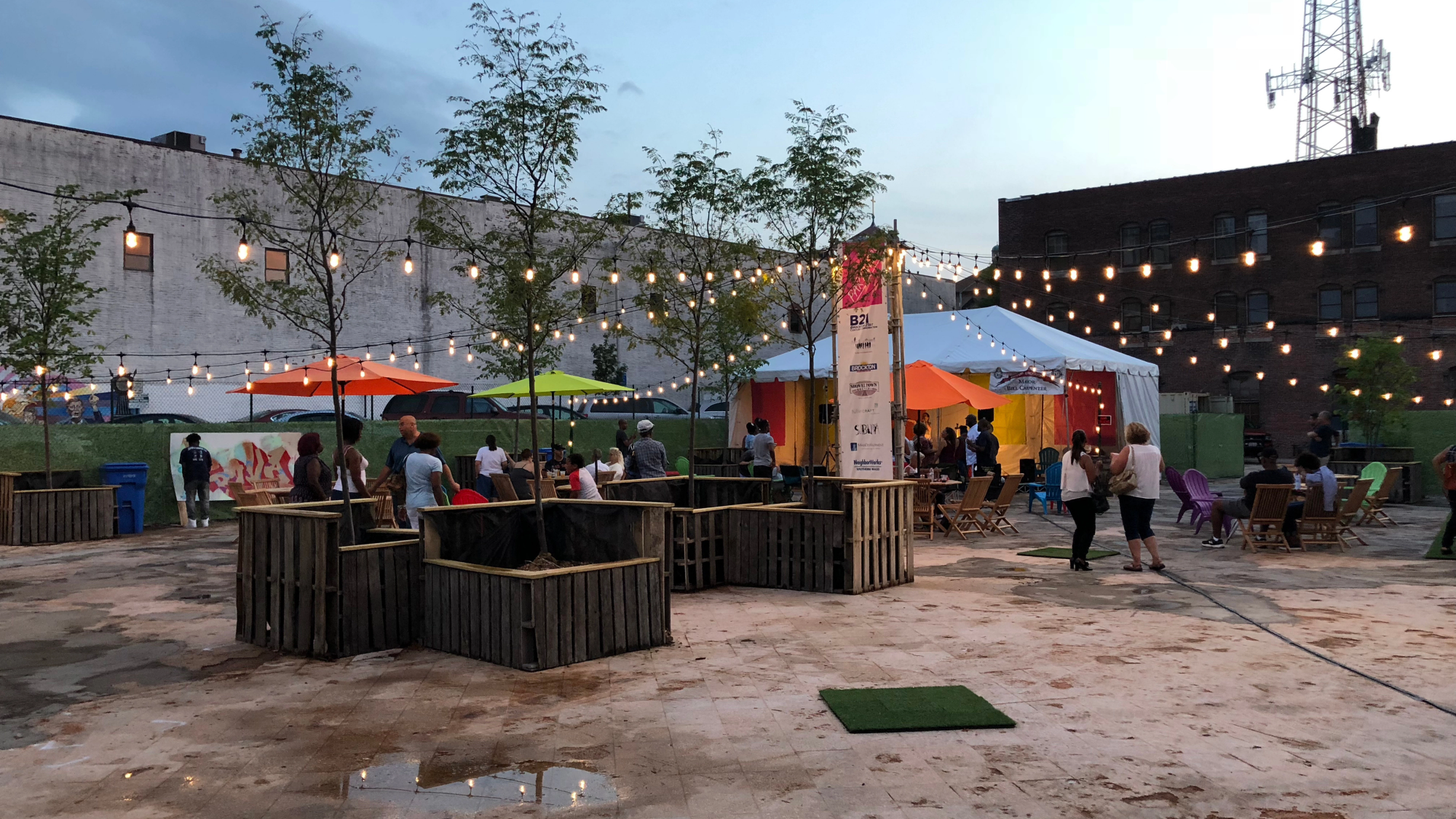 PROVA! Brockton placemaking pop-up with outdoor seating, shade umbrellas, and string lighting.