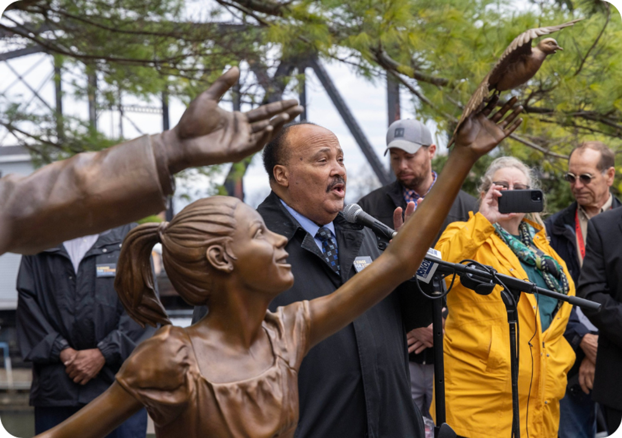 A gentleman gives a speech at the opening ceremony for the monuments