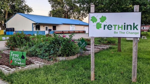ReThink's garden and office, flanked by a logo sign stating "Be The Change."