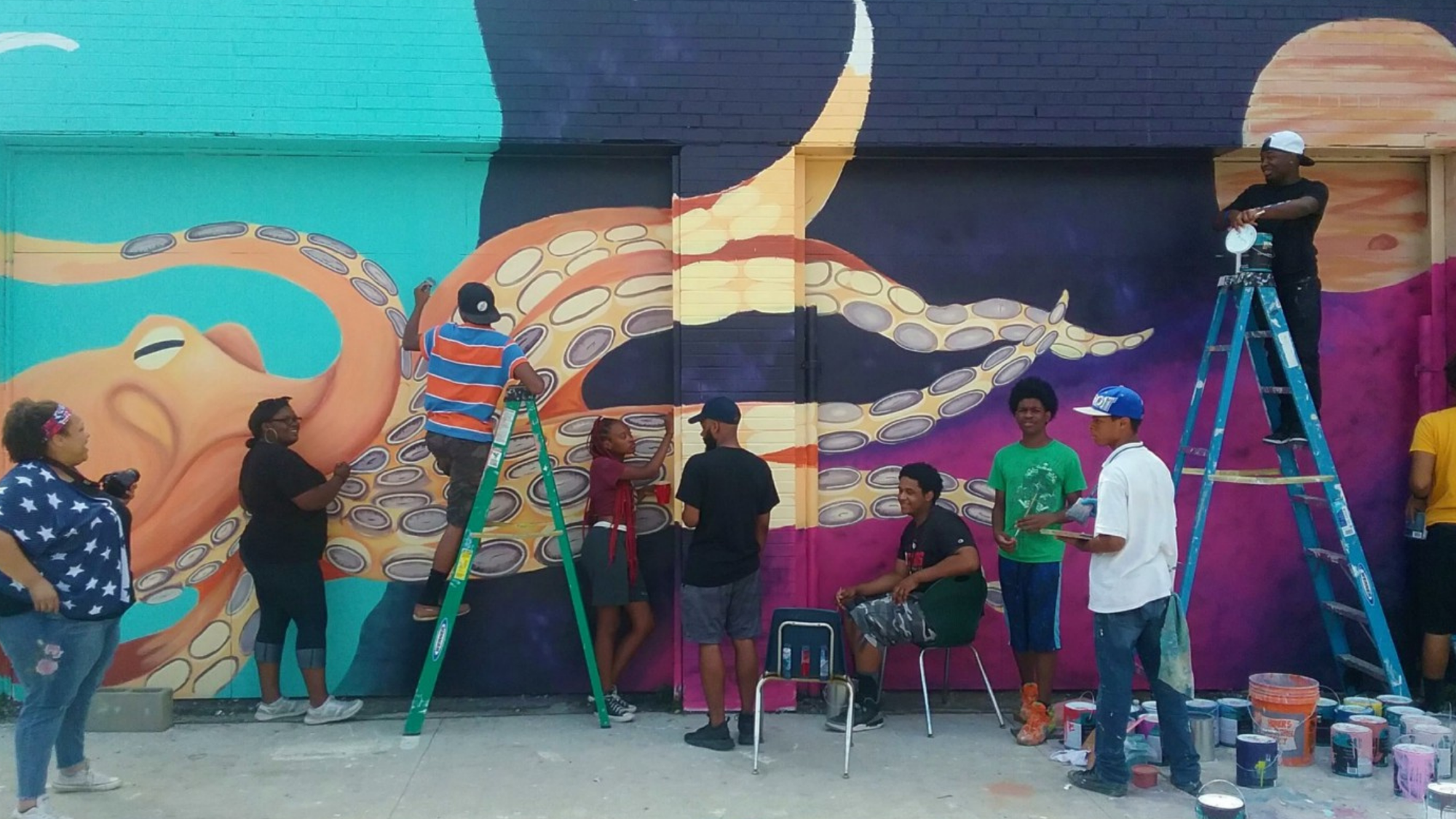 Students paint a colorful mural of an octopus. 