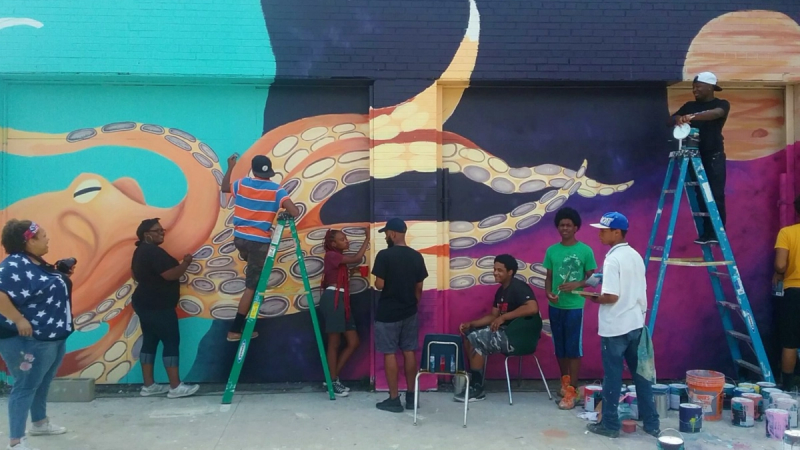 Students paint a colorful mural of an octopus. 
