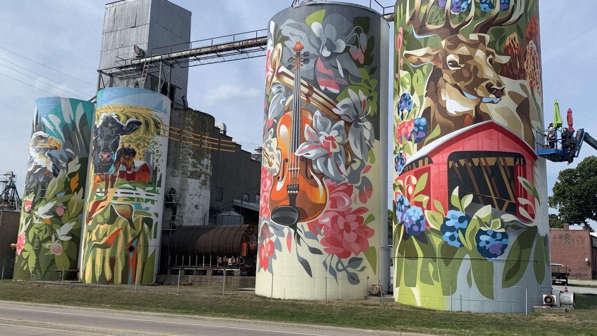Putnam County Mural Project in Indiana features painted grain silos with colorful murals.