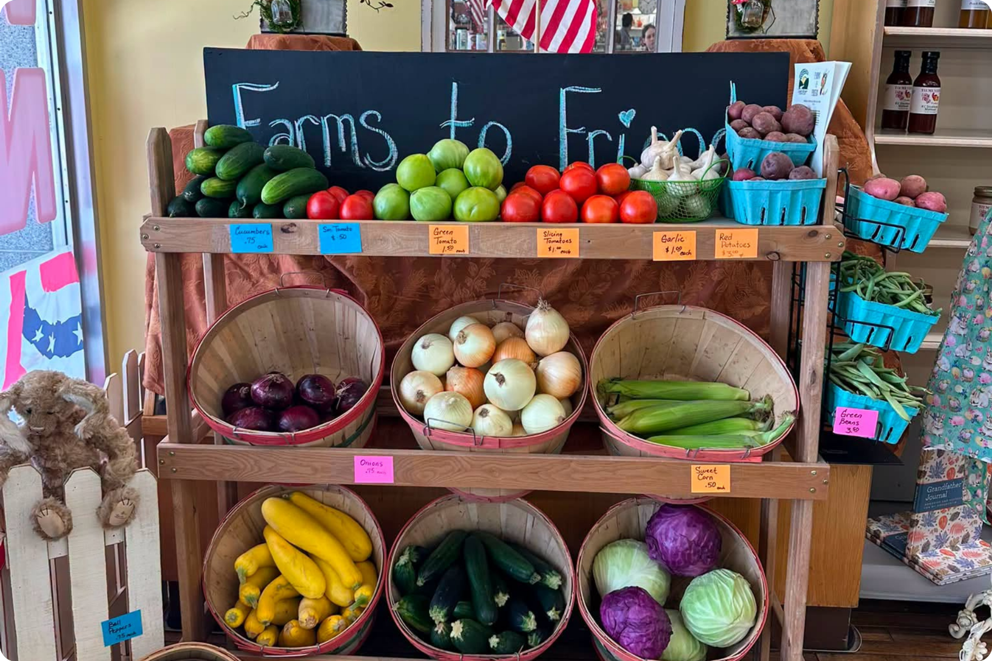 A shelf displaying an assortment of vibrant vegetables, displayed in stacks or in baskets.