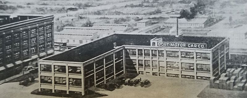 A black and white vintage photo of the Dort Motor Car Company.