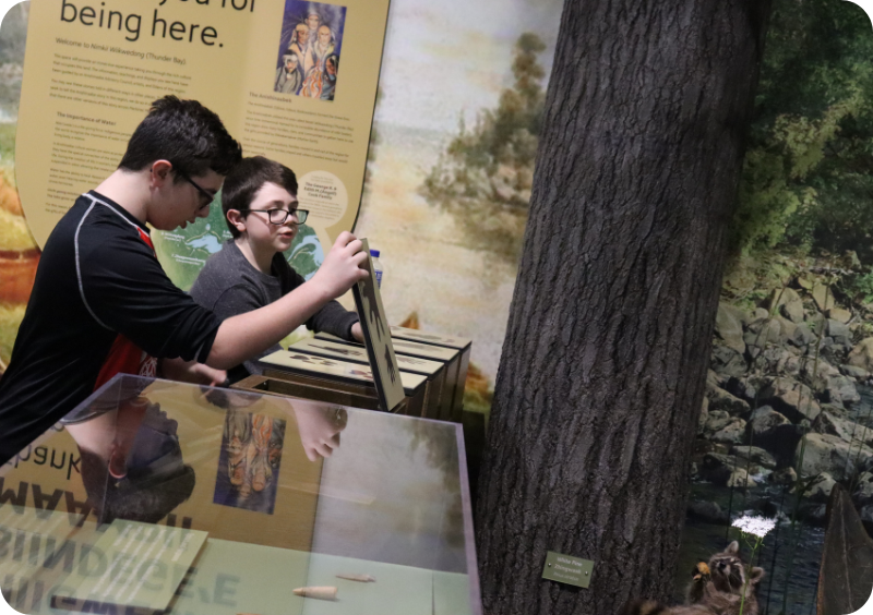 Young boys check out the discover boxes