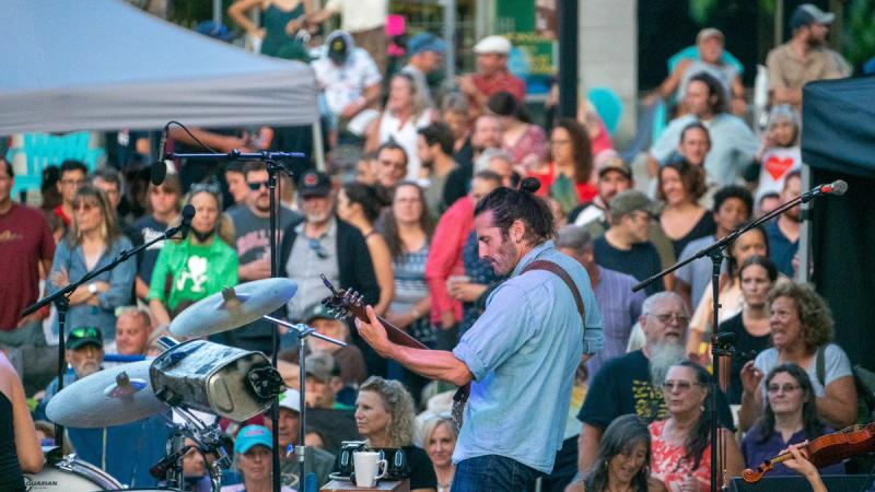 St. Johnsbury Final Fridays event series full of people watching a guitarist on stage