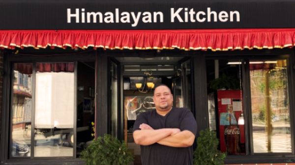 Jeremy Lockett stands in front of his restaurant, Himalayan Kitchen. 