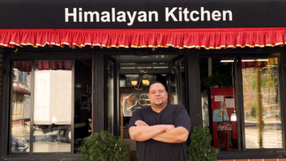 Jeremy Lockett stands in front of his restaurant, Himalayan Kitchen.