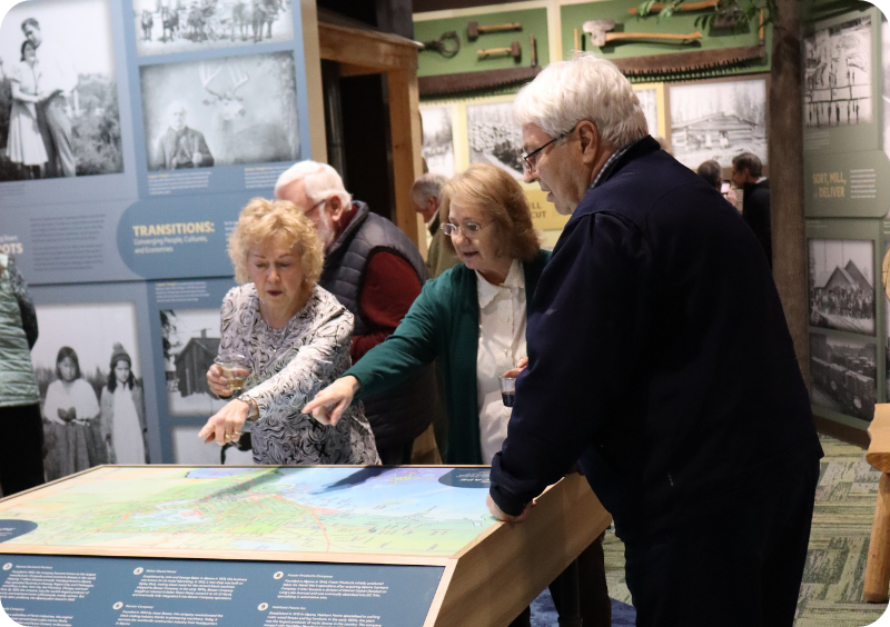 Community members explore the interactive Michigan map table