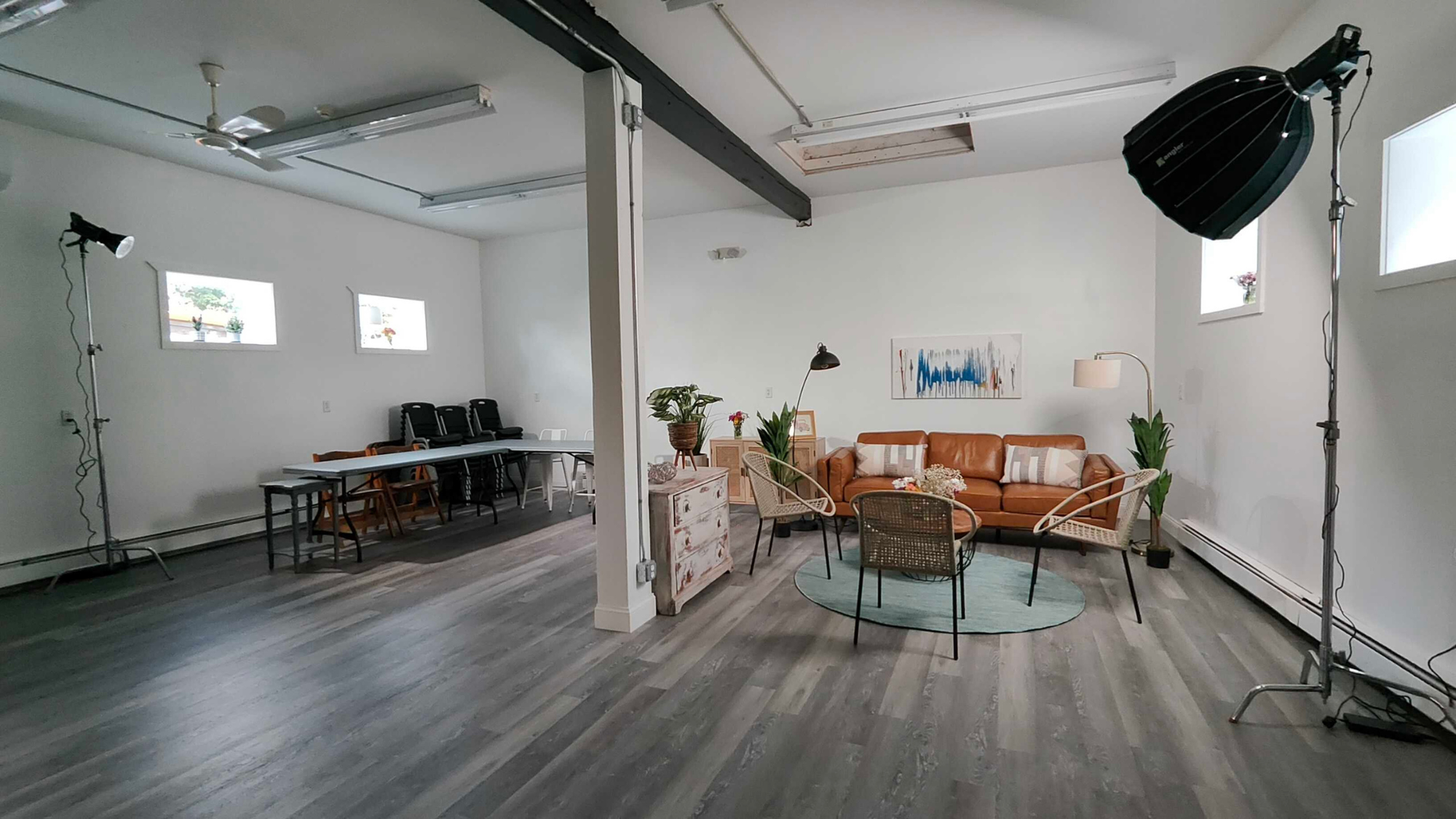Inside EmVision’s new creative studio space with AV equipment and inviting furniture in an open white box. 