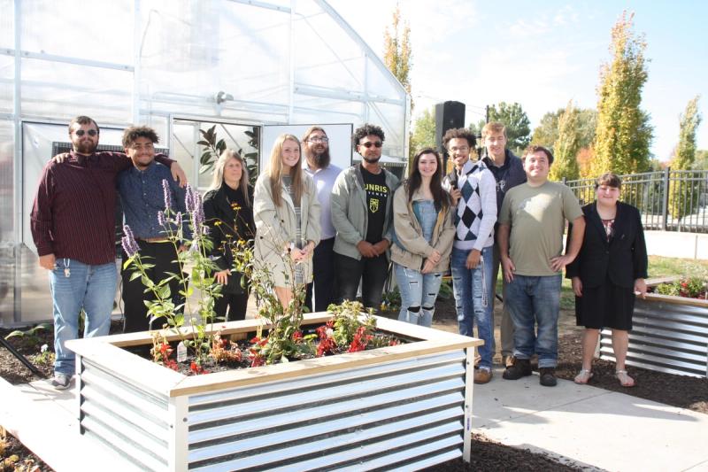 Students gather around the greenhouse with pride having participated in making it happen. 