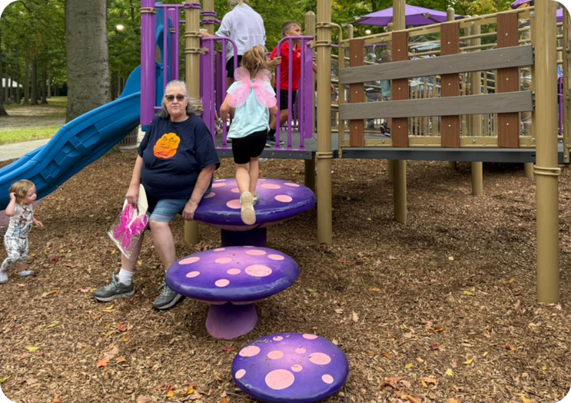 A girl with fairy wings bounces up purple, mushroom-shaped platforms 