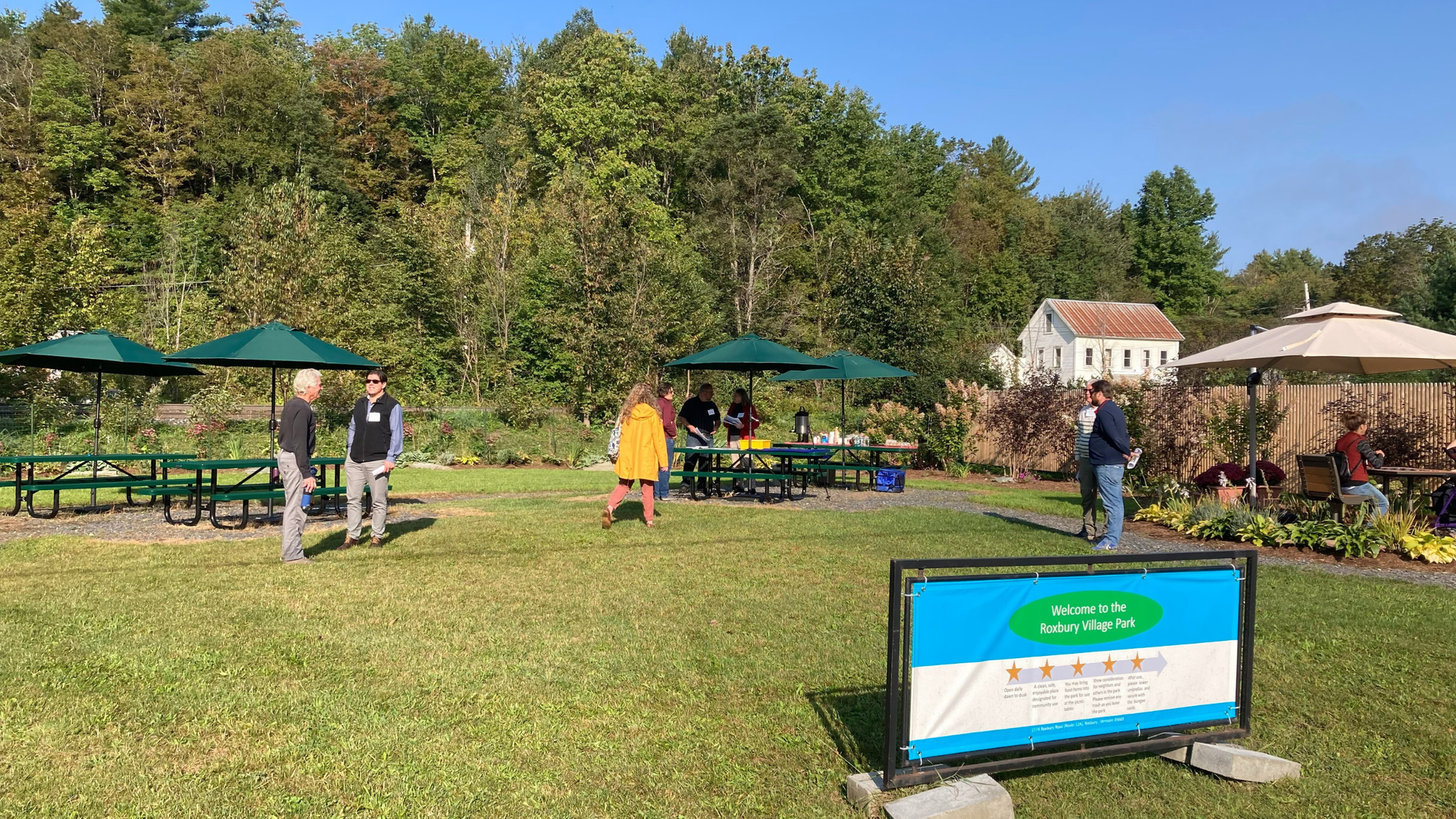 Roxbury Village Park features picnic tables with umbrellas for shade, landscaping, and greenspace to play.