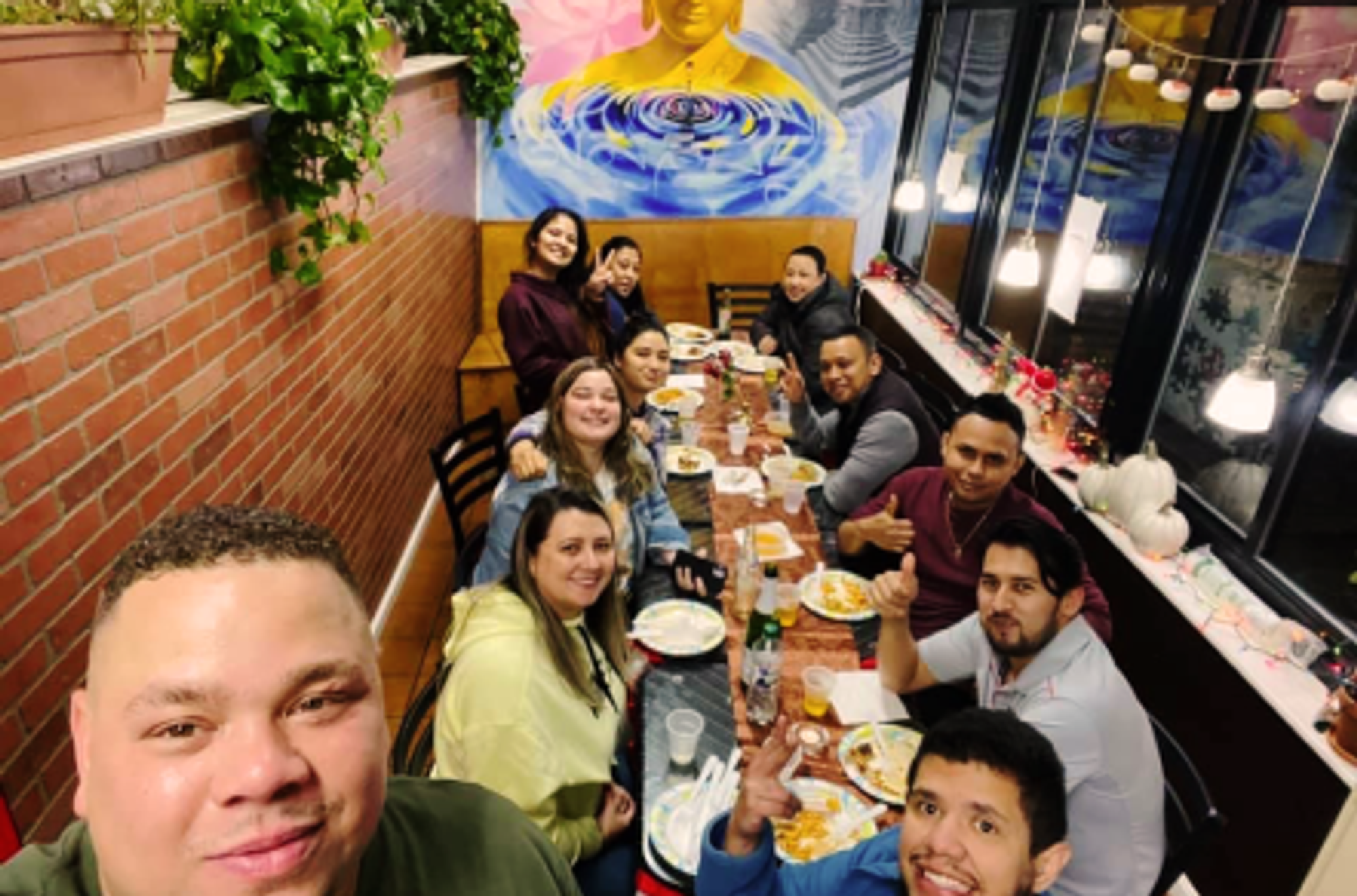 Friends and family gathered around eating at Himalayan Kitchen.