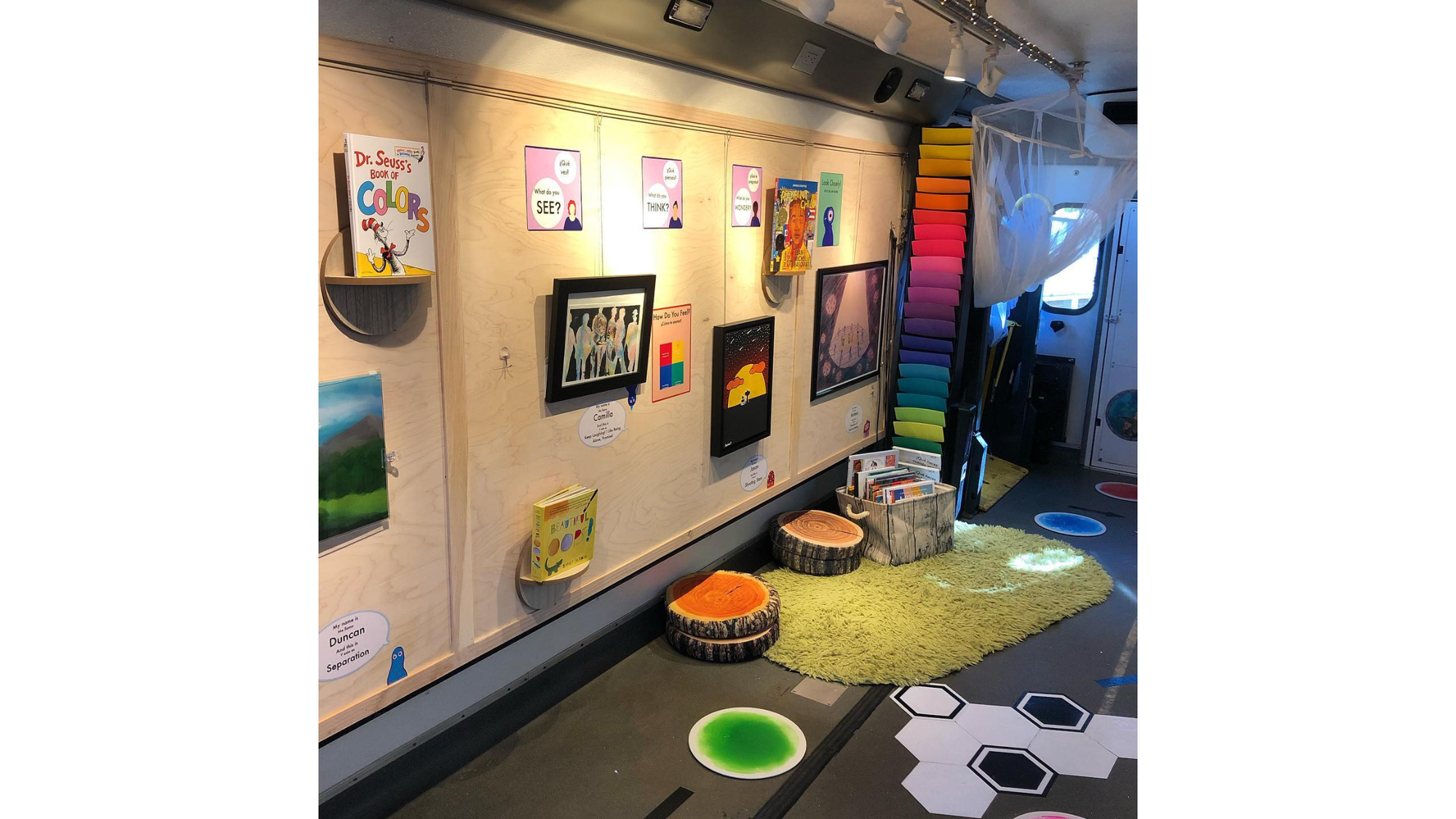 The inside of the Cartie art gallery inside a bus. Full of colorful artwork. 