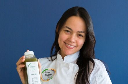 Chef Yesenia Melo holds a healthy, green beverage and smiles to the camera. 
