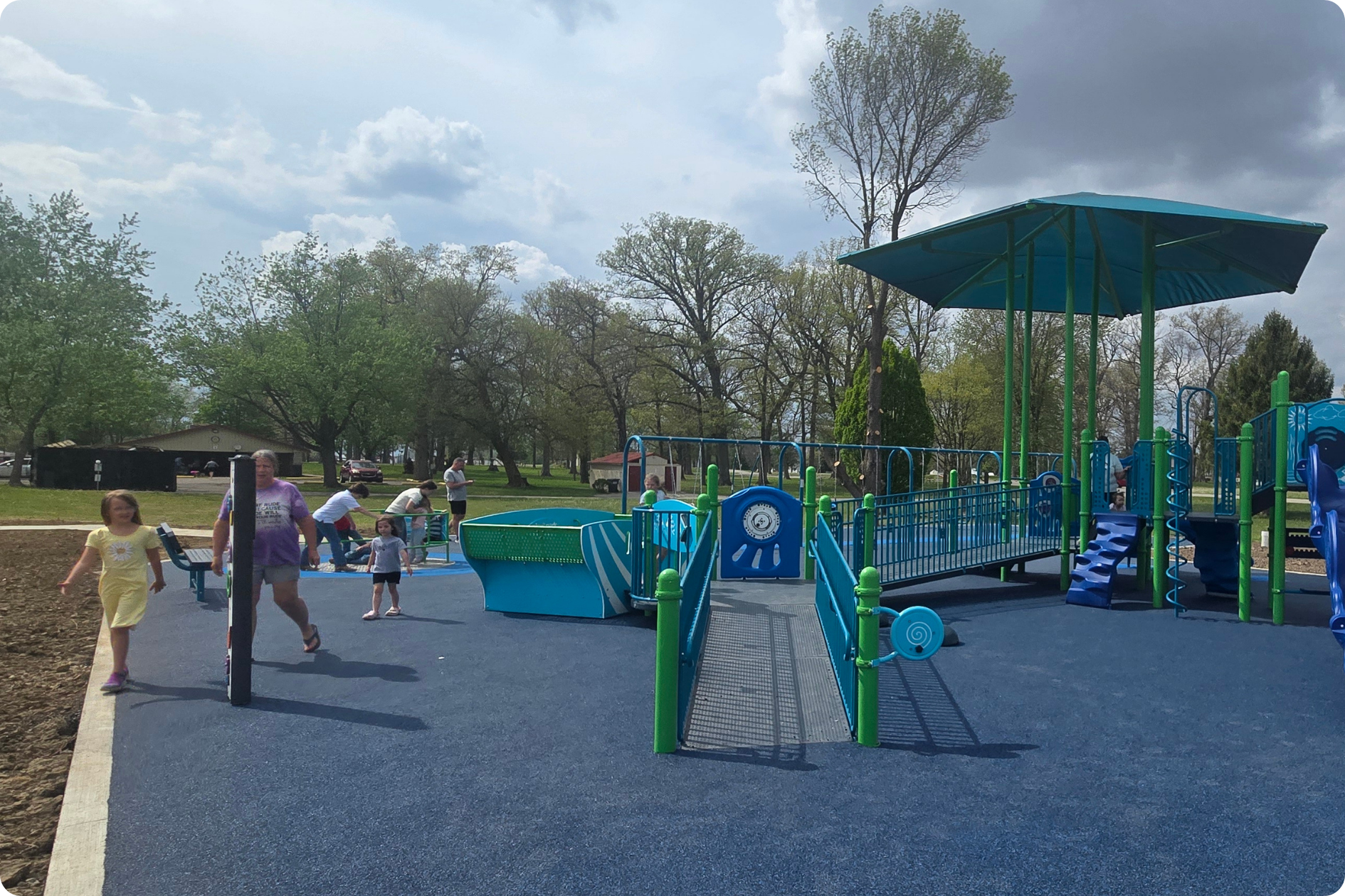 Kids gather and play at the inclusive new playground at Harter Park.