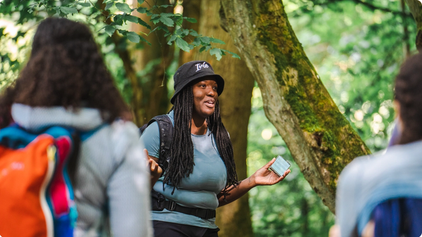 A young woman speaks to a group at Remington Woods in Bridgeport, CT.