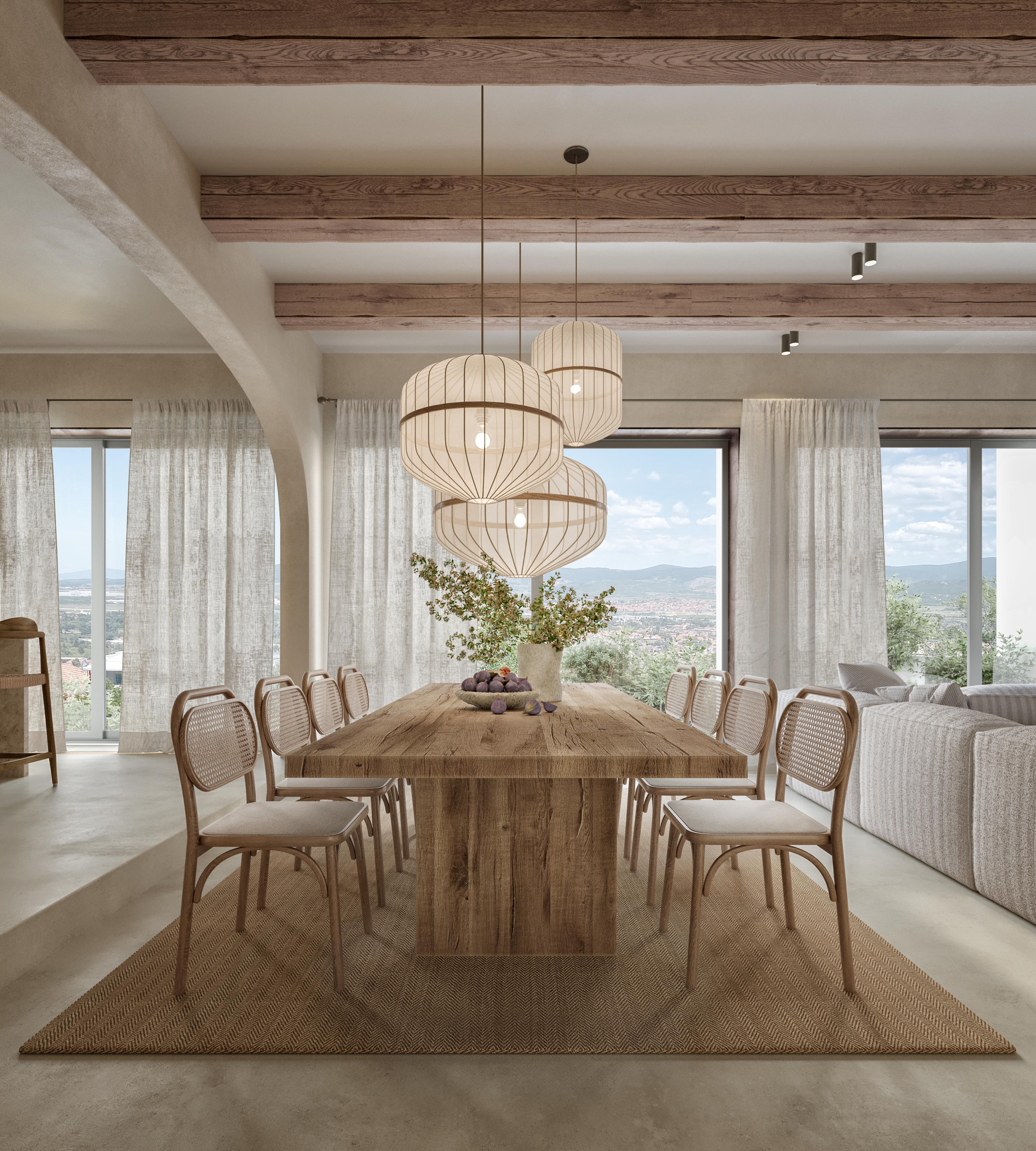 Dining room with a long oak table, woven chairs and large drum pendant lights