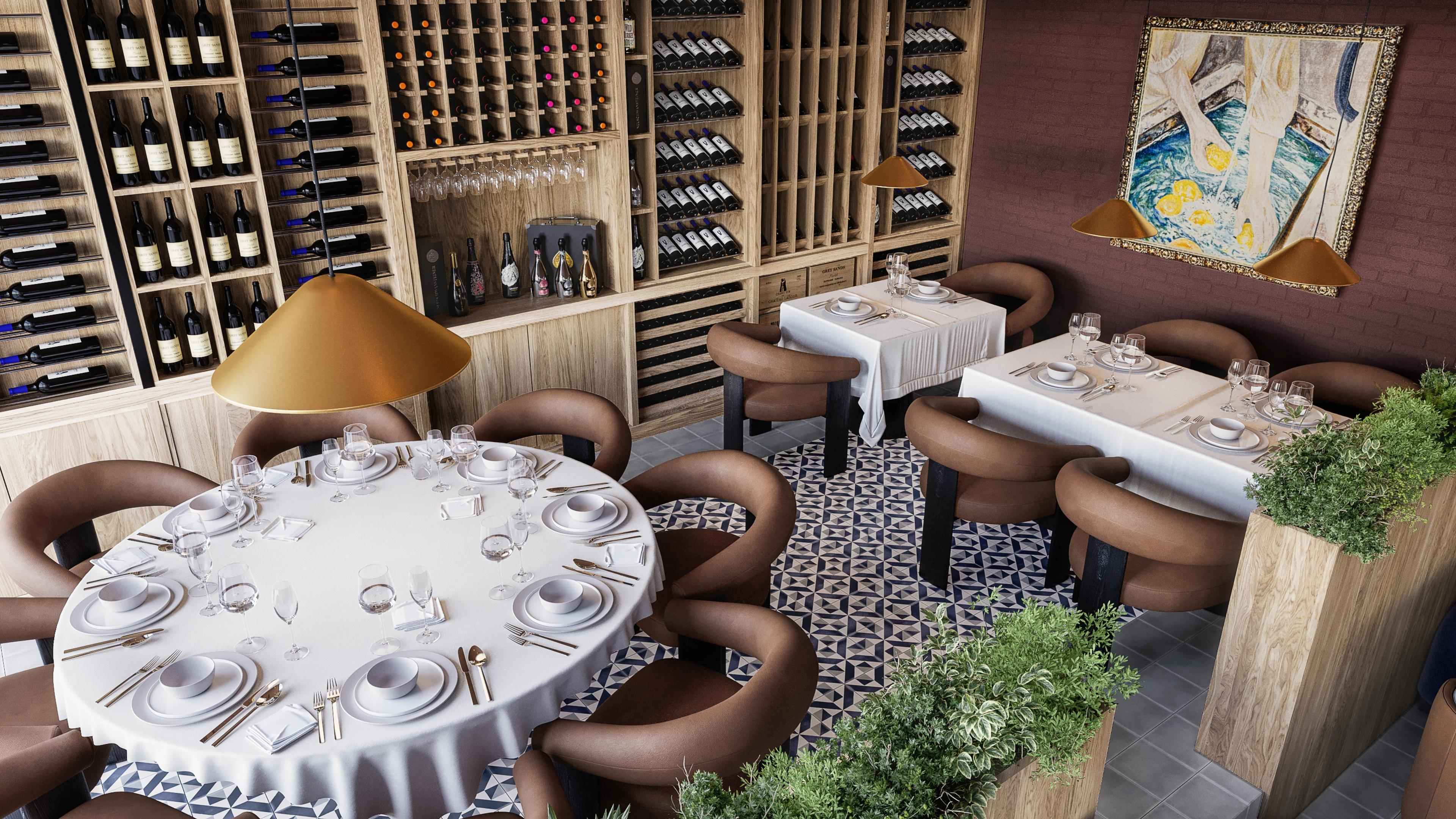 Round table set for dinner beside a wine wall with brown leather chairs