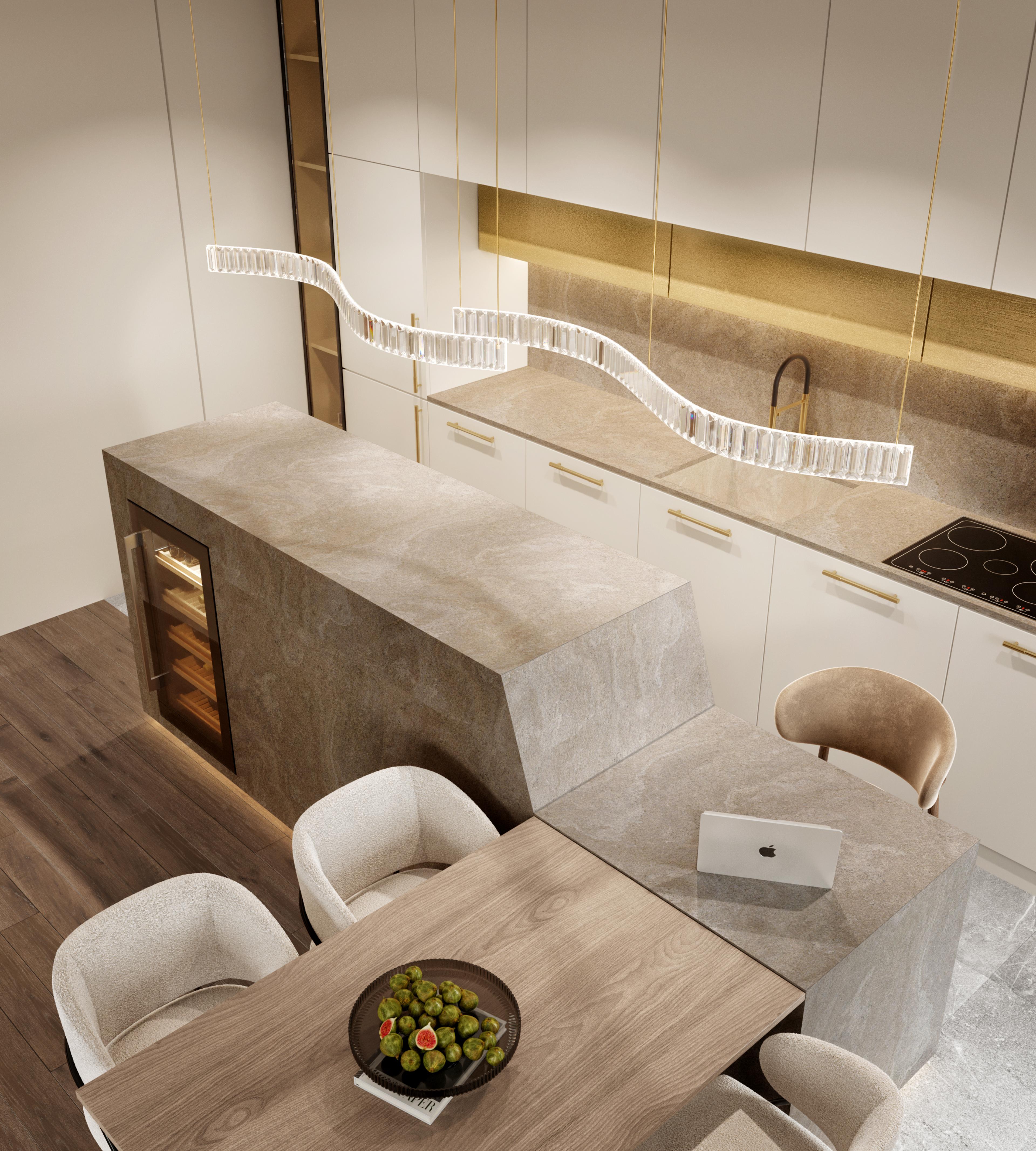 Kitchen island in stone with a wavy crystal light above and a dining table with cream chairs
