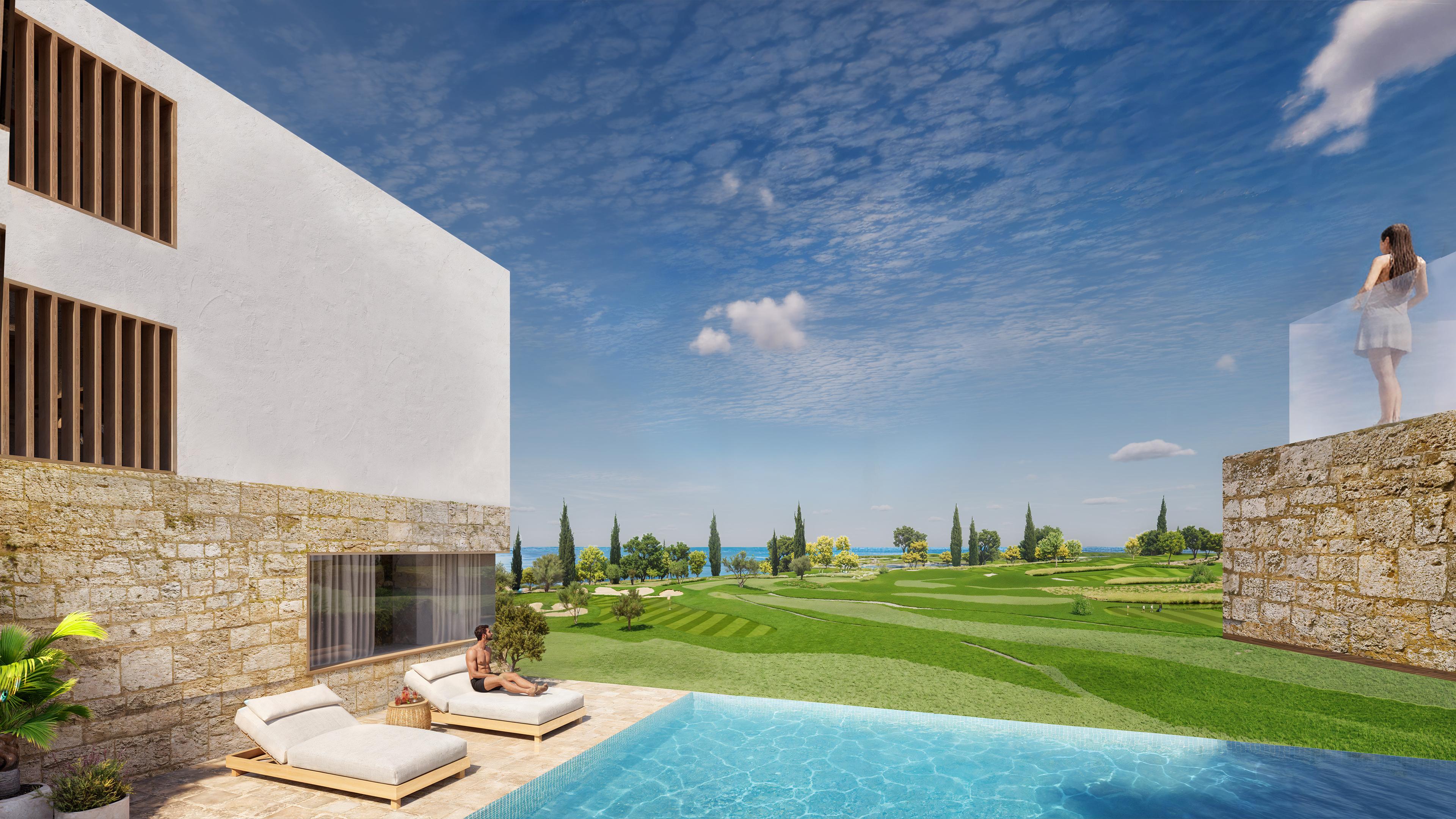 Terraced stone residences with a pool and the sea on the horizon