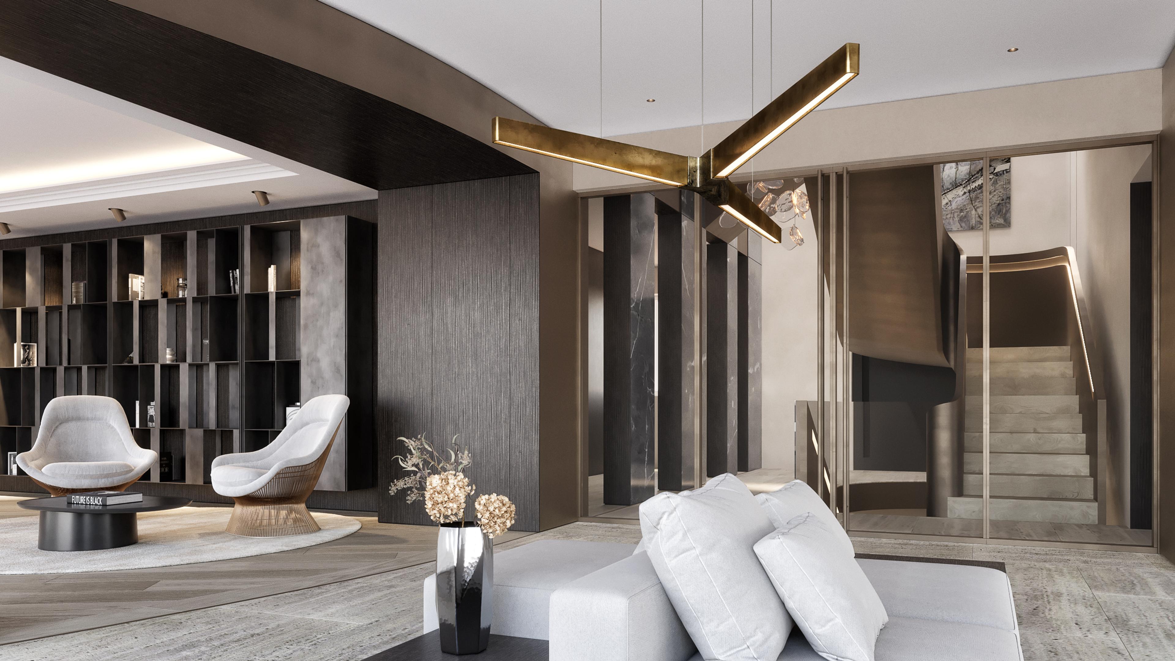 Open living area with a brass pendant light and a lit staircase in the background