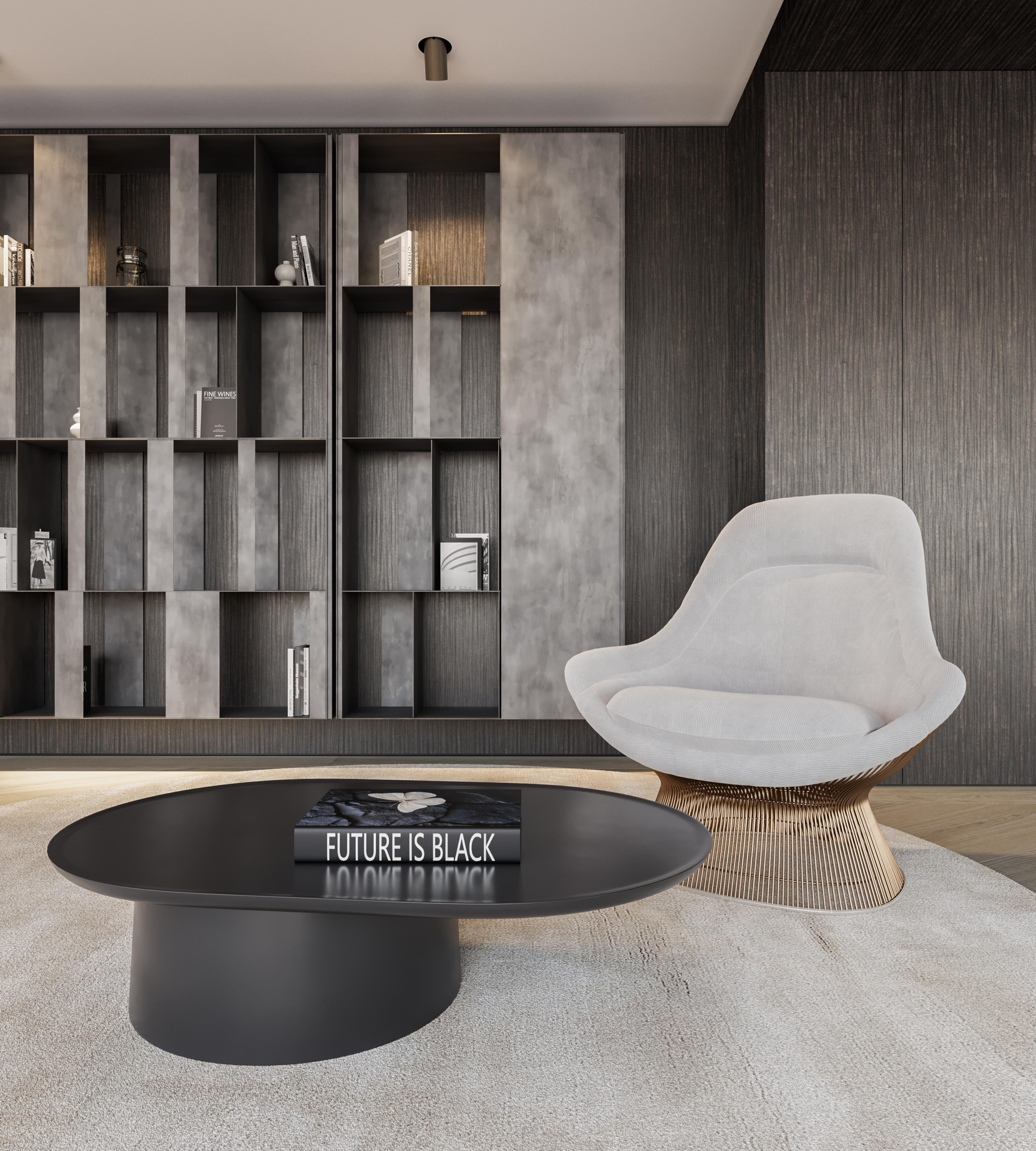 Living room with a pale lounge chair, black oval coffee table and a grey shelving wall