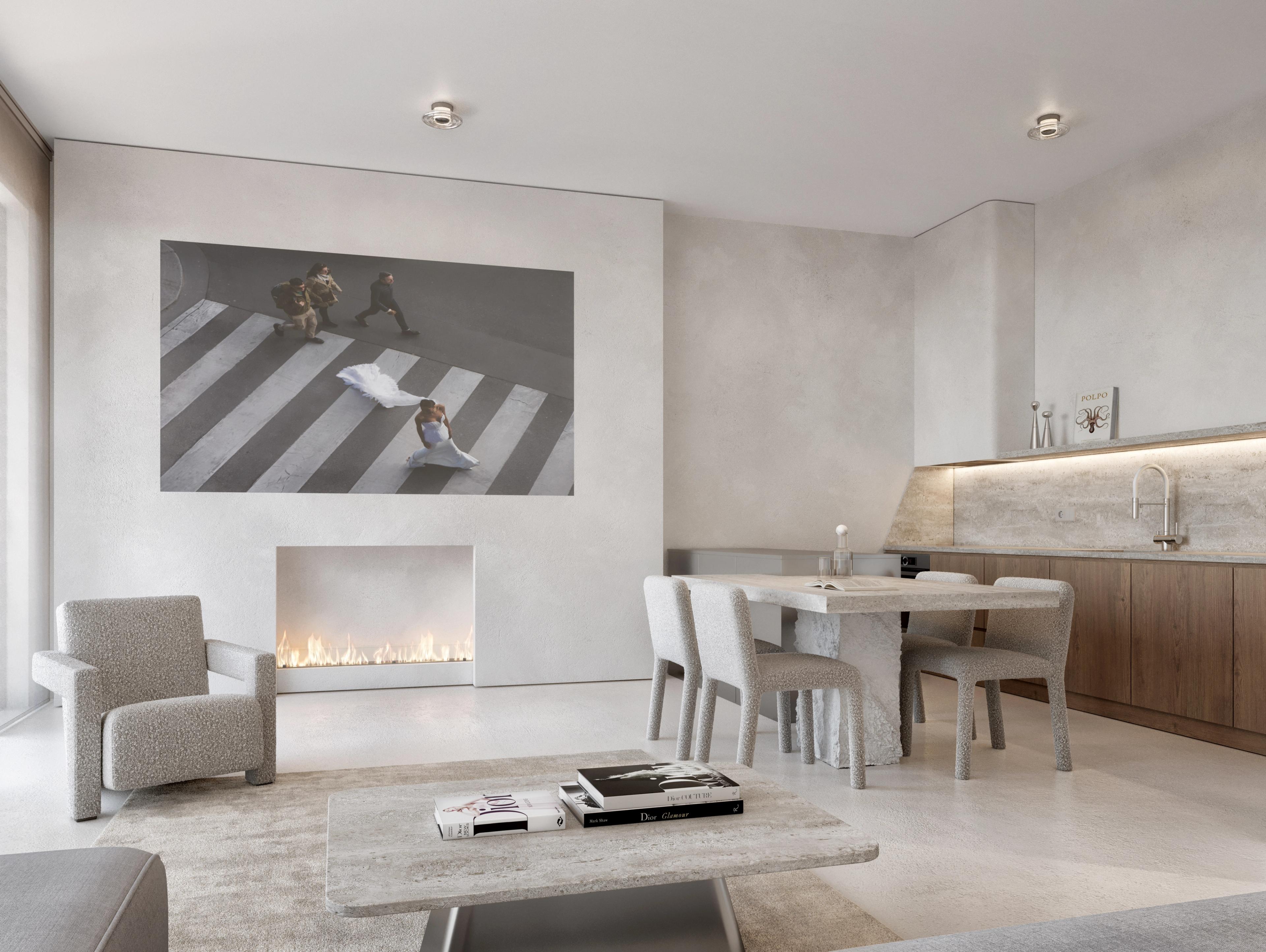 Living and dining space with a plaster fireplace, a large framed artwork and a dining table with grey chairs