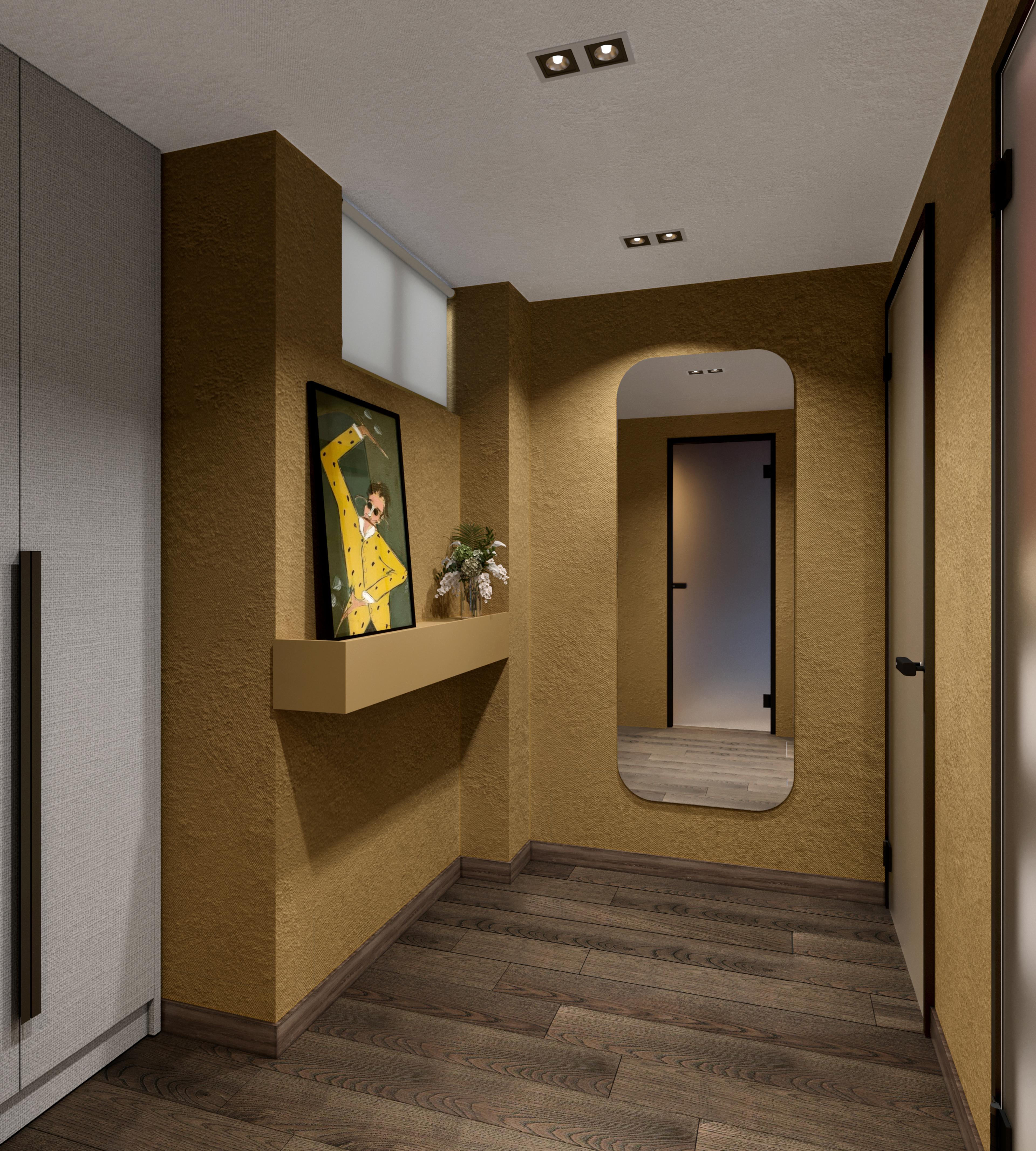 Corridor to the restrooms with ochre walls, a framed artwork and an arched mirror