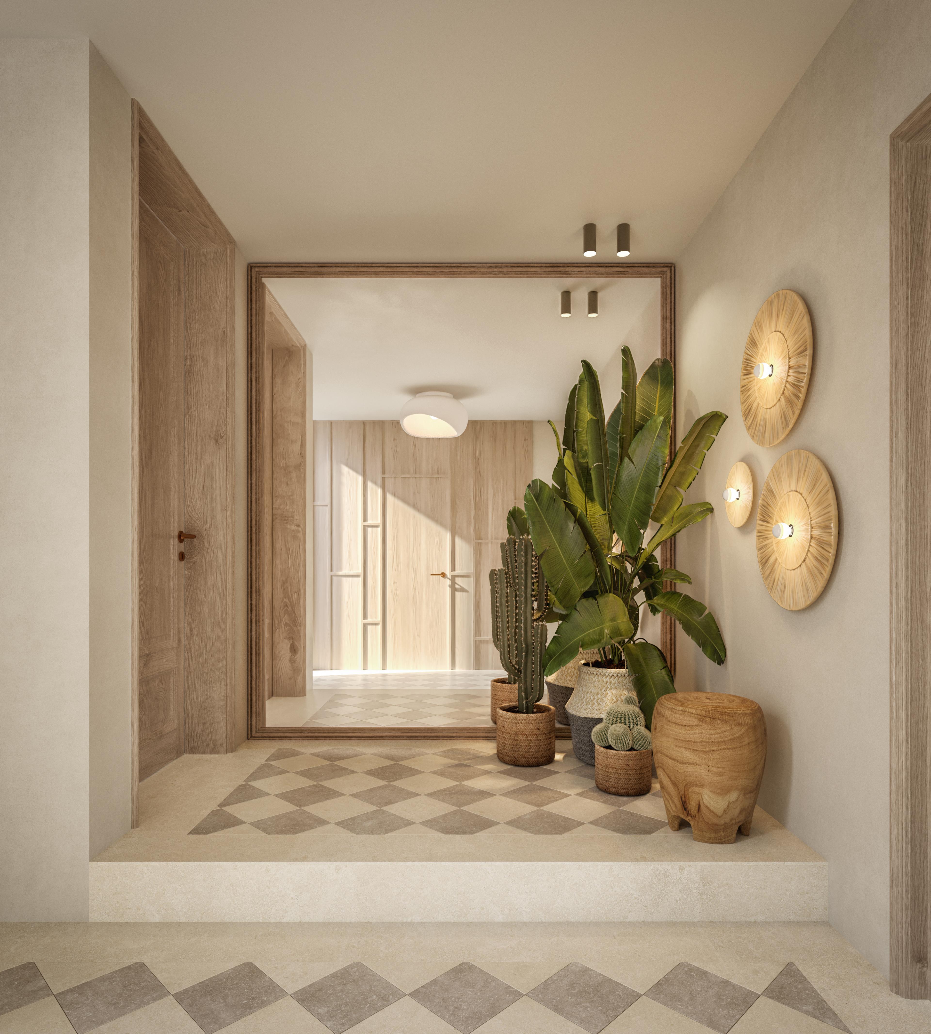 Entrance with a large mirror, round wall lights and a plant on a chequered floor