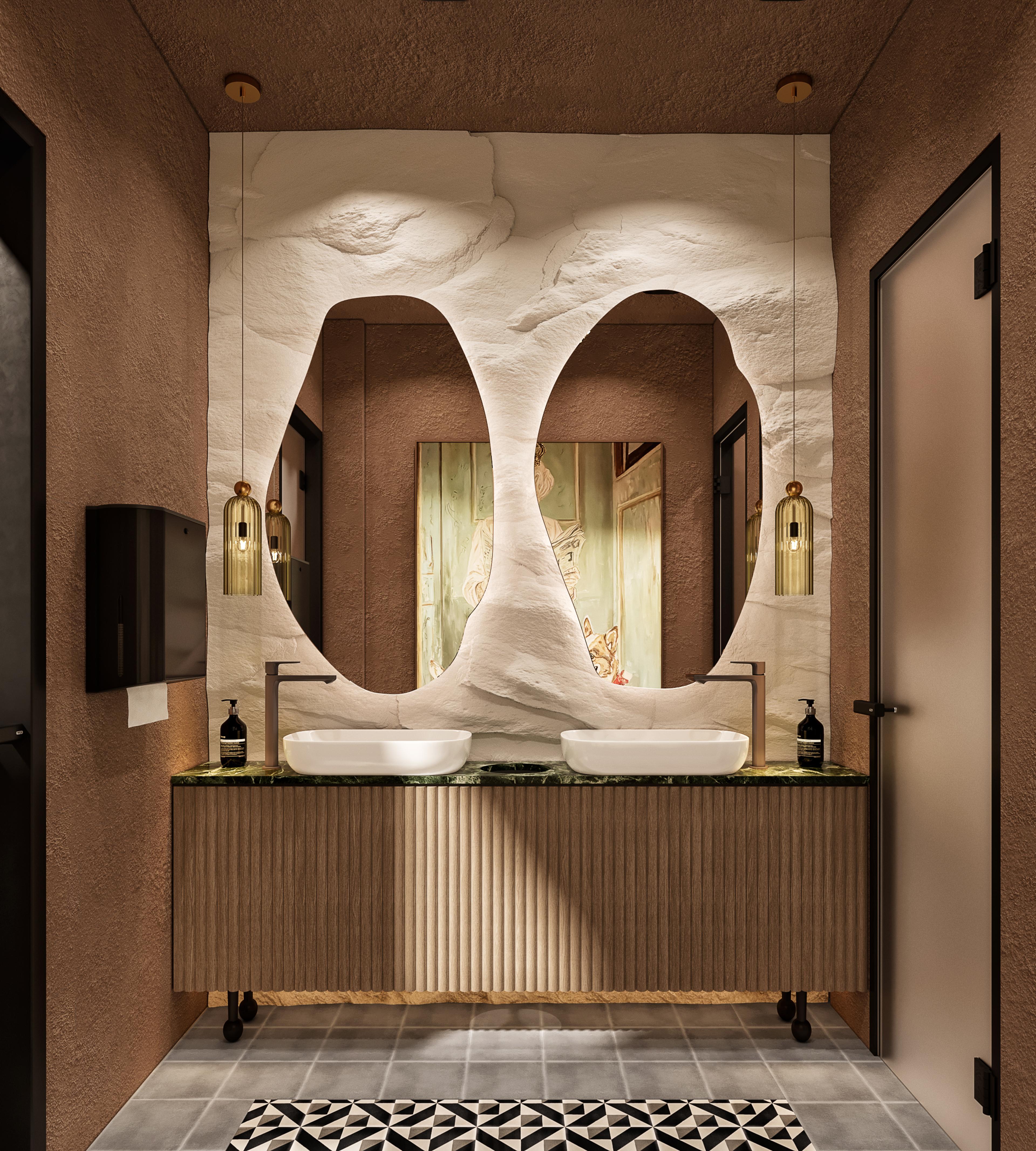 Restroom with two sculpted organic mirrors, stone washbasins and a fluted wood vanity