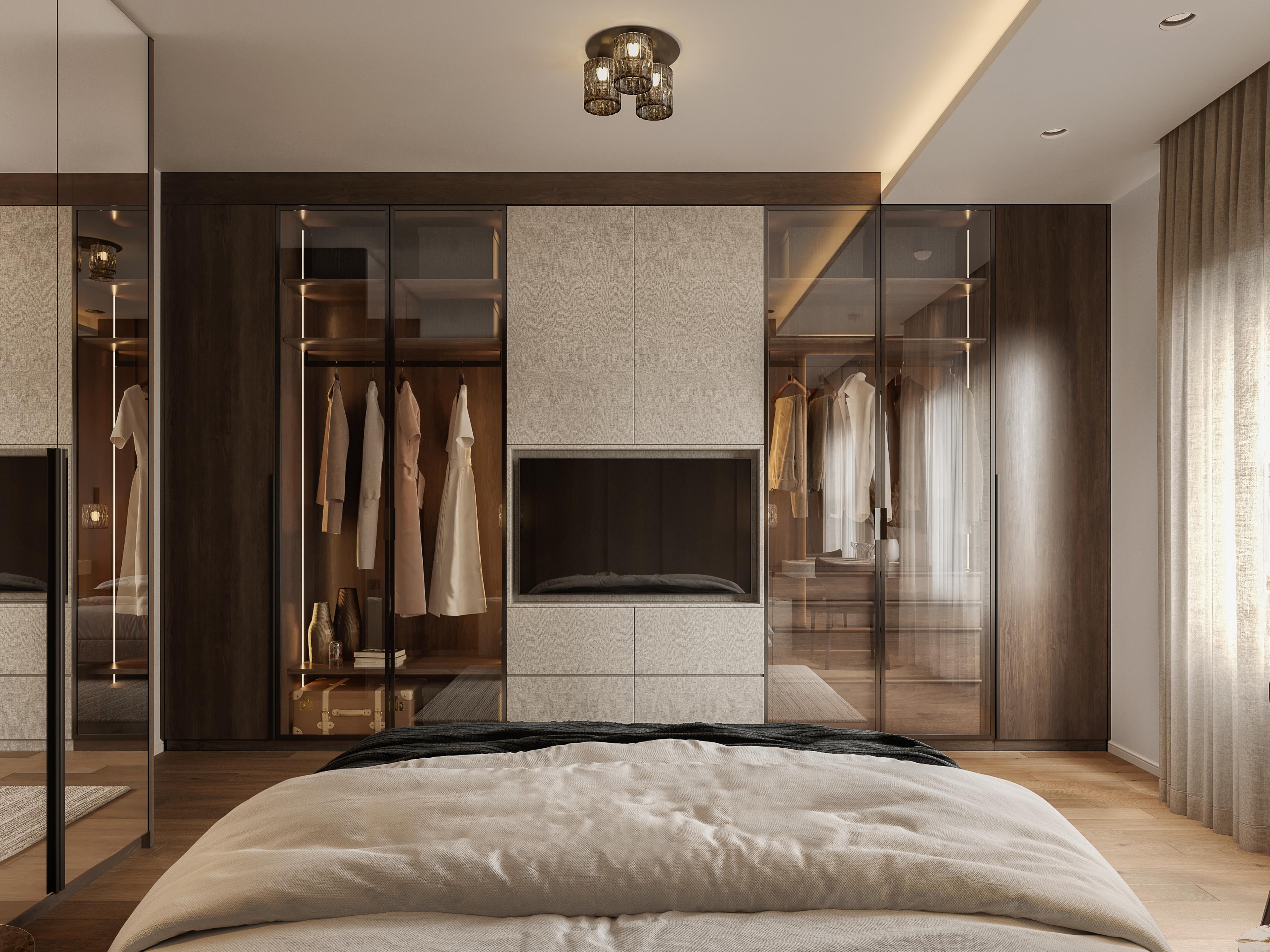 Bedroom wardrobe wall with glass-fronted closets and a TV, behind the foot of the bed