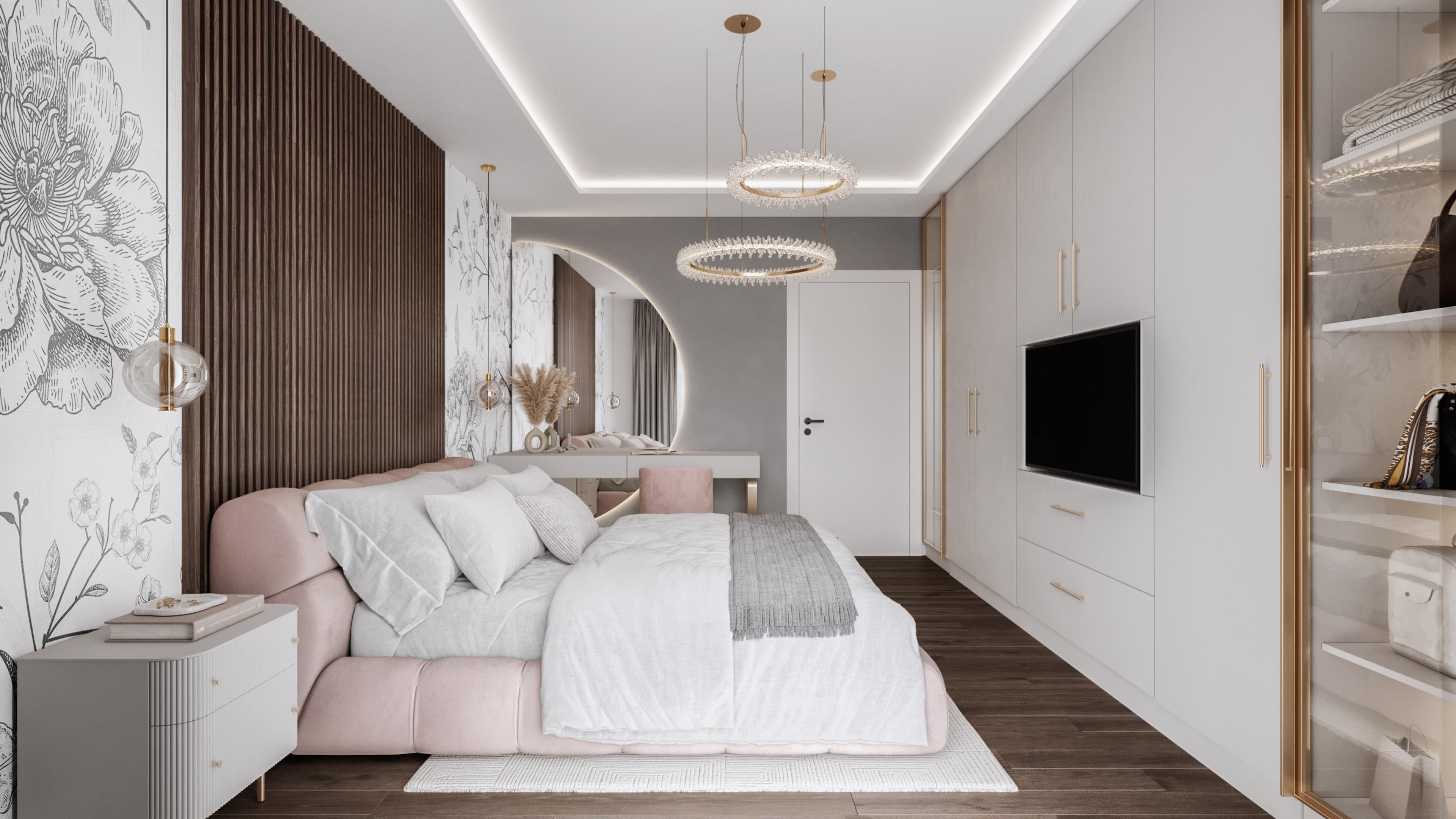 Bedroom seen from the side with a pink upholstered bed, a dressing table and a TV wall