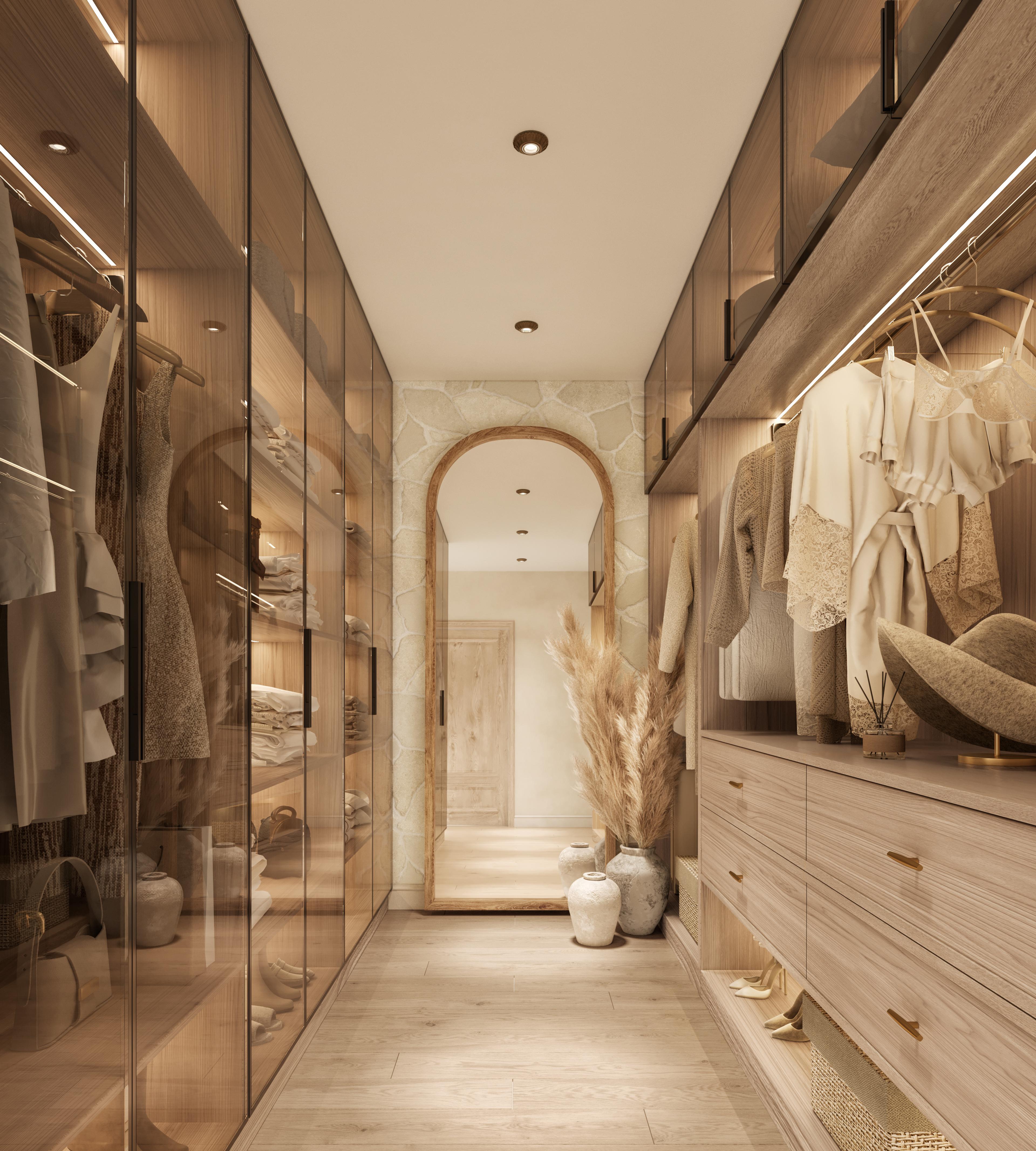 Walk-in wardrobe corridor with glass-fronted shelving and an arched mirror at the end