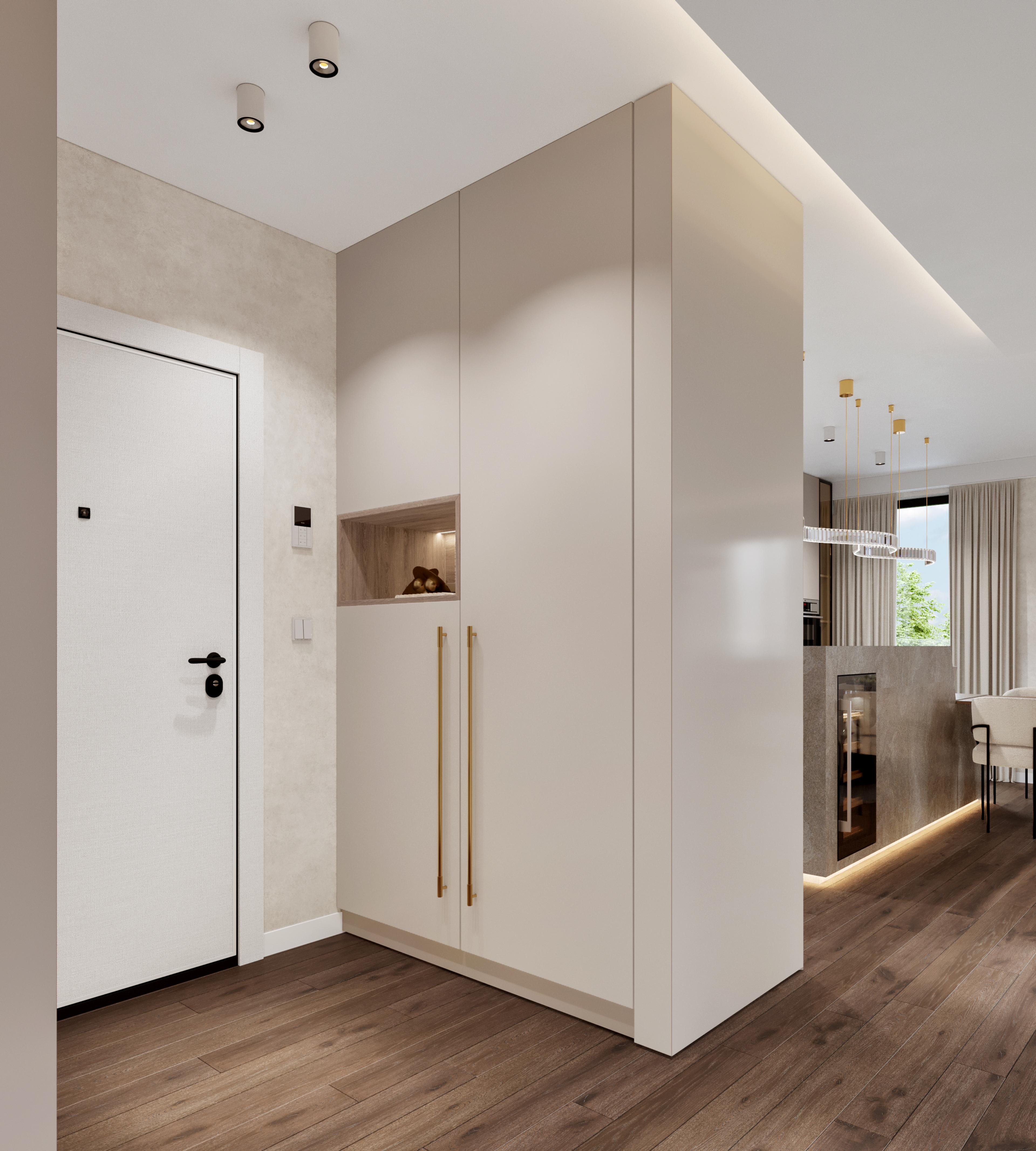 Entrance hall with a cream storage wall and brass handles, opening to the kitchen