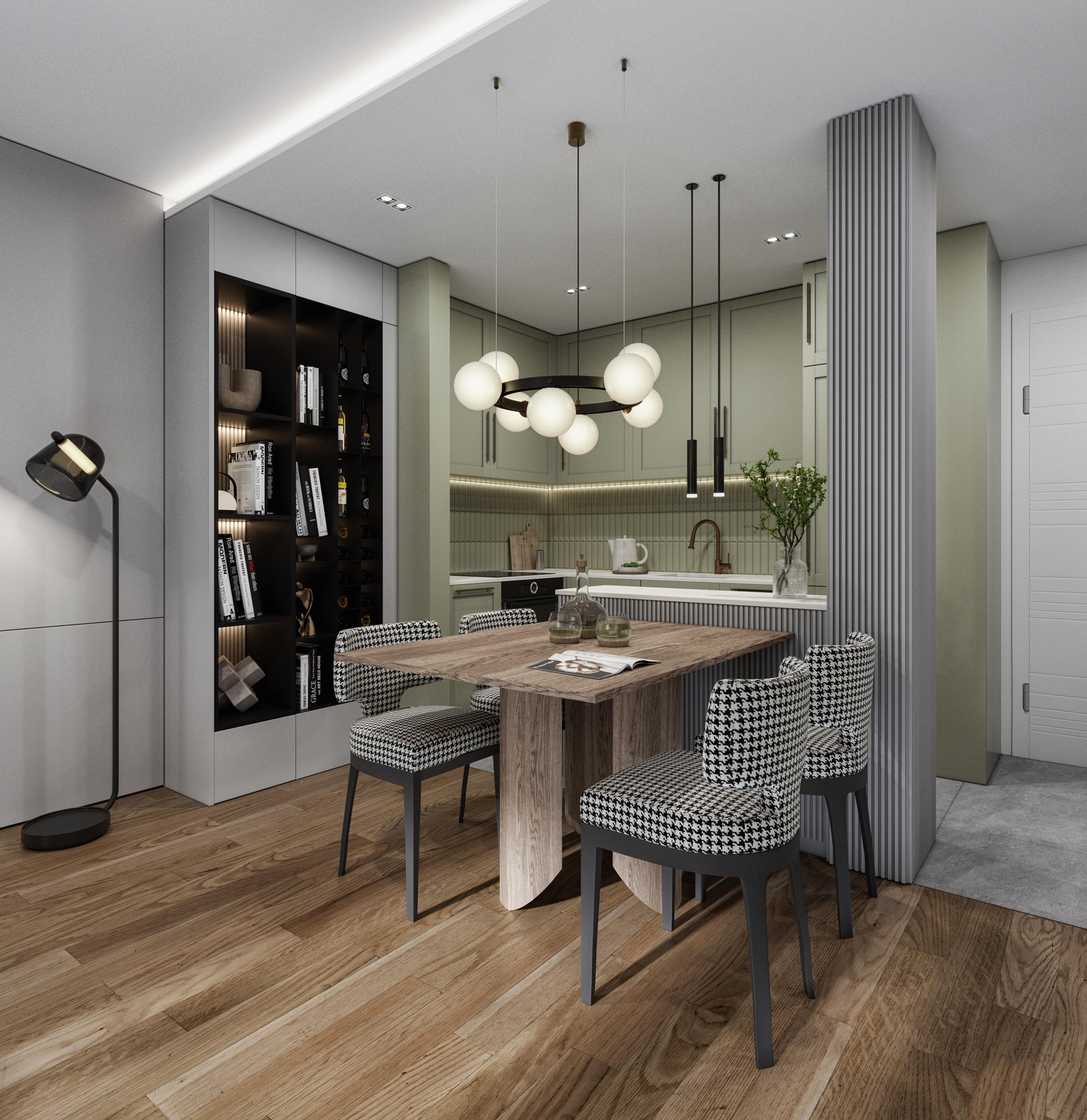 Dining nook with a wooden table, houndstooth chairs and a black bookcase beside the green kitchen