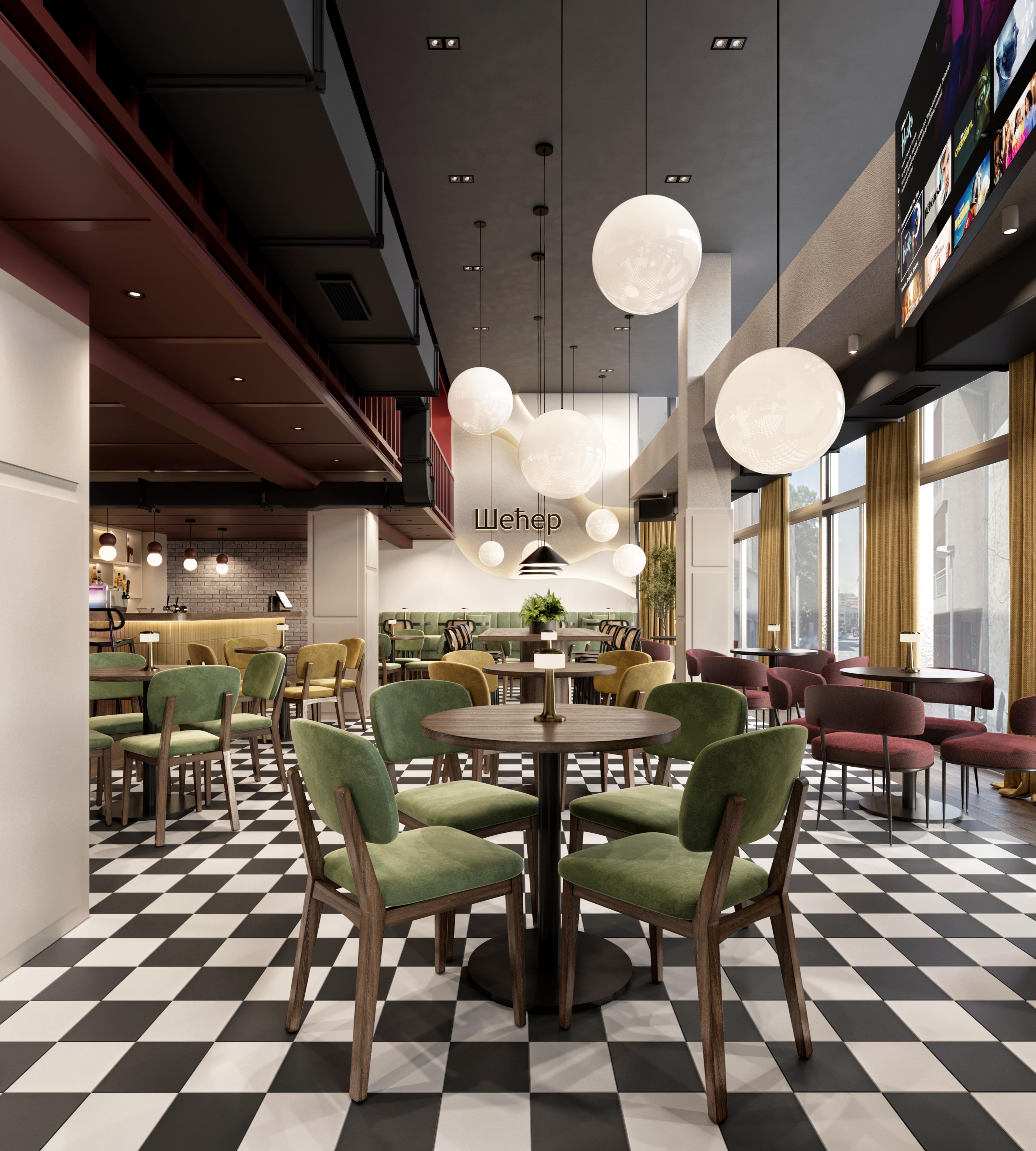 Cafe floor with green velvet chairs, white globe lights and a chequered floor
