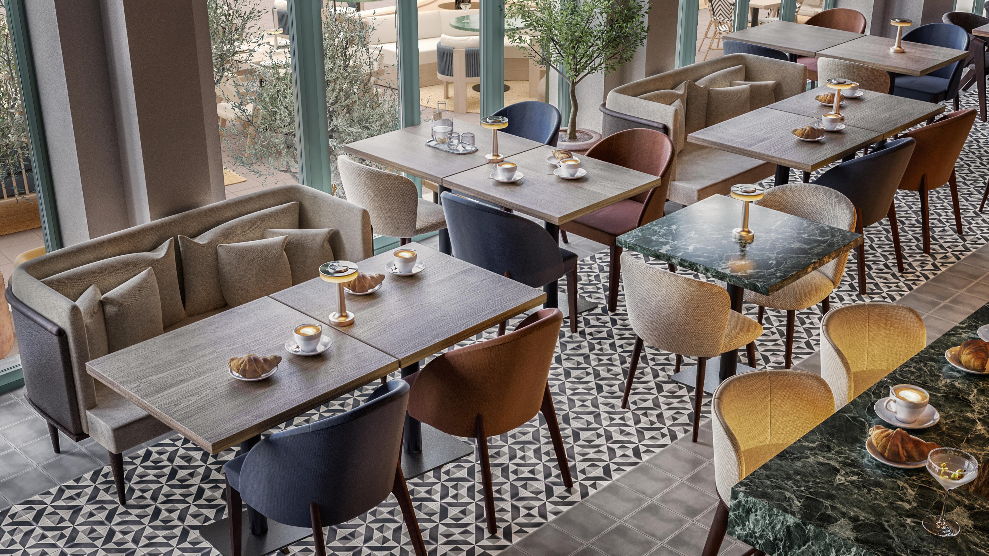 Window-side seating with banquettes, green marble tables and coffee and pastries